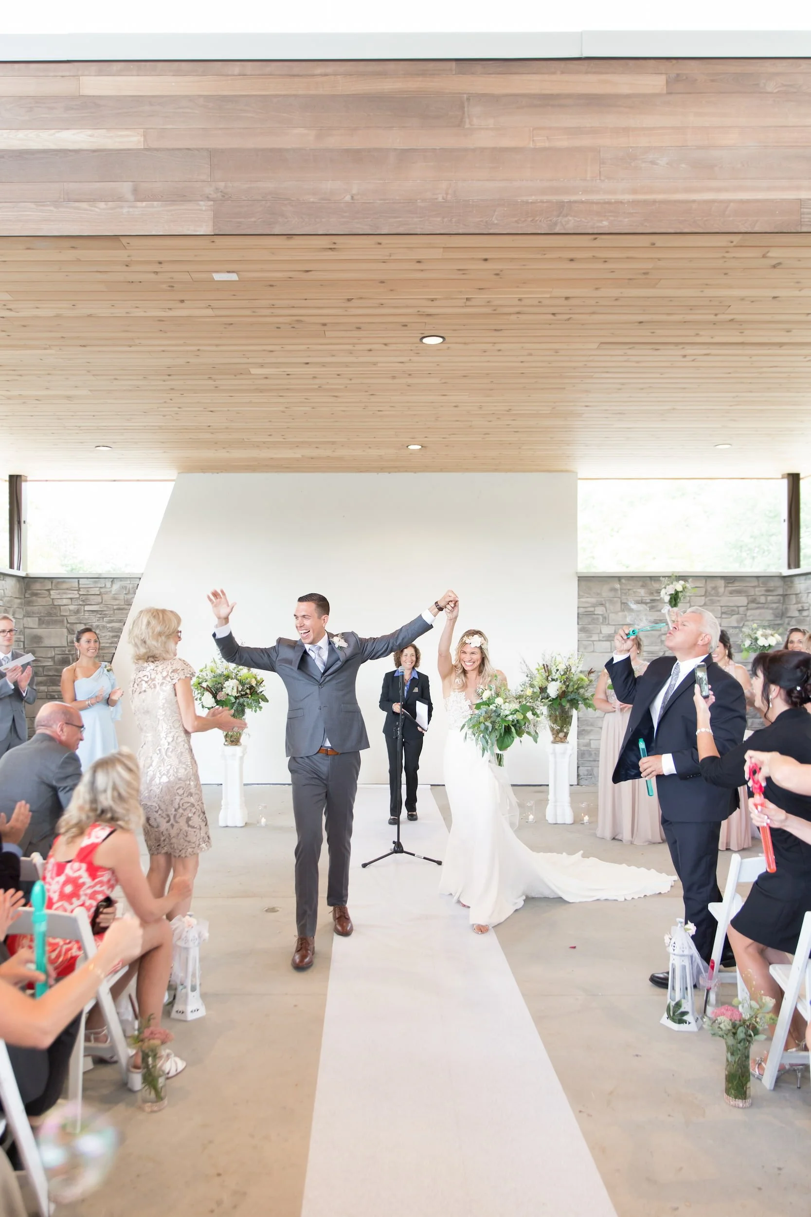 Wedding ceremony recessional cheering at Guild Inn Estate indoor venue