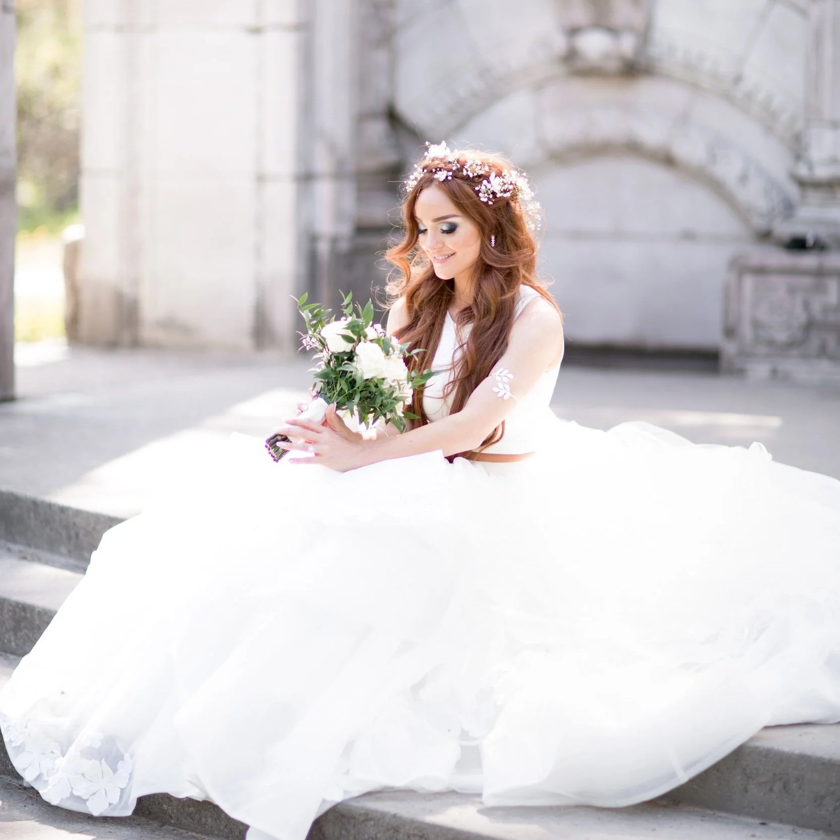Bride perched on stone steps at her Guild Inn Estate wedding in Scarborough, Ontario
