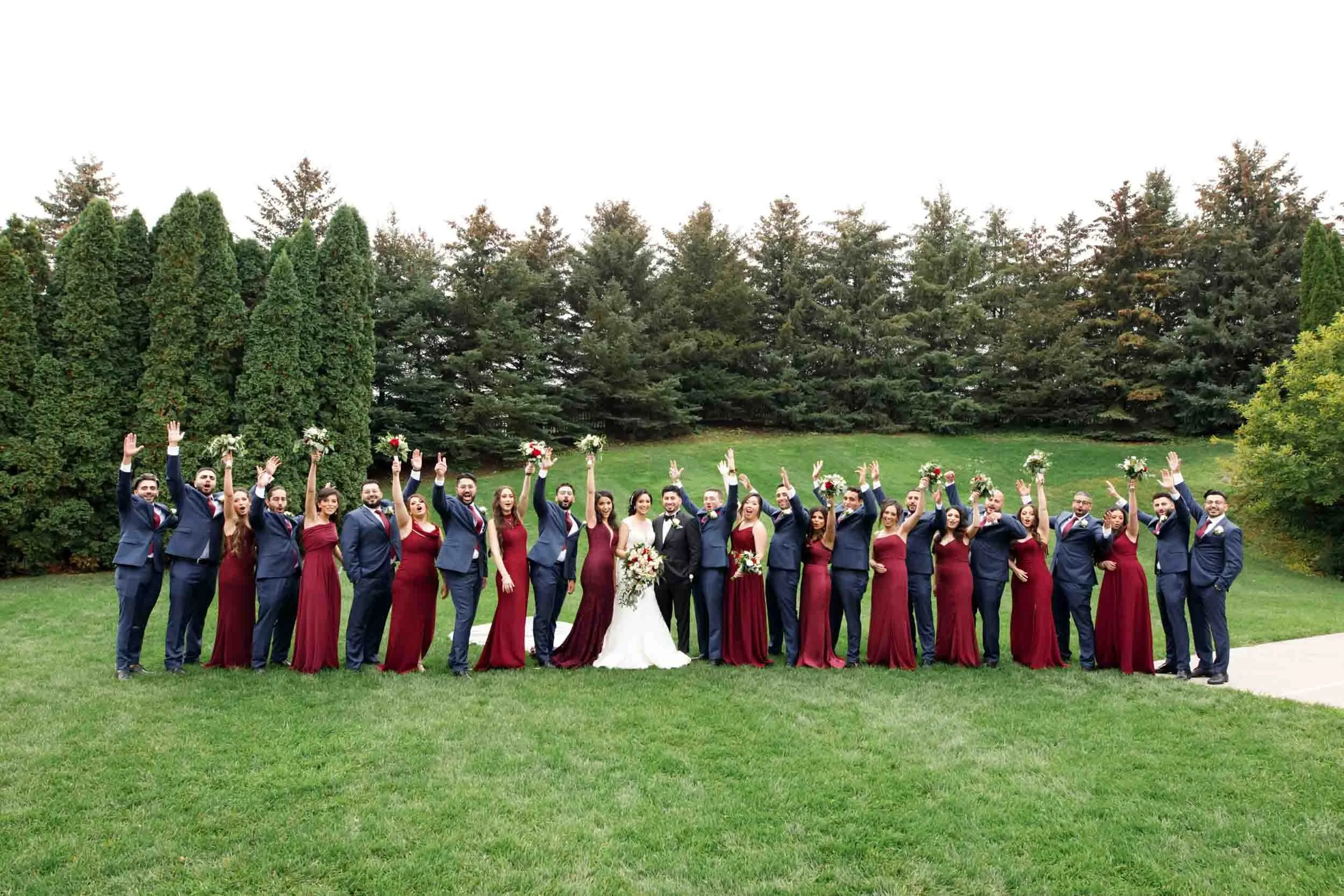 Full wedding party lined up across the grounds at The Manor Event Venue wedding in King, Ontario