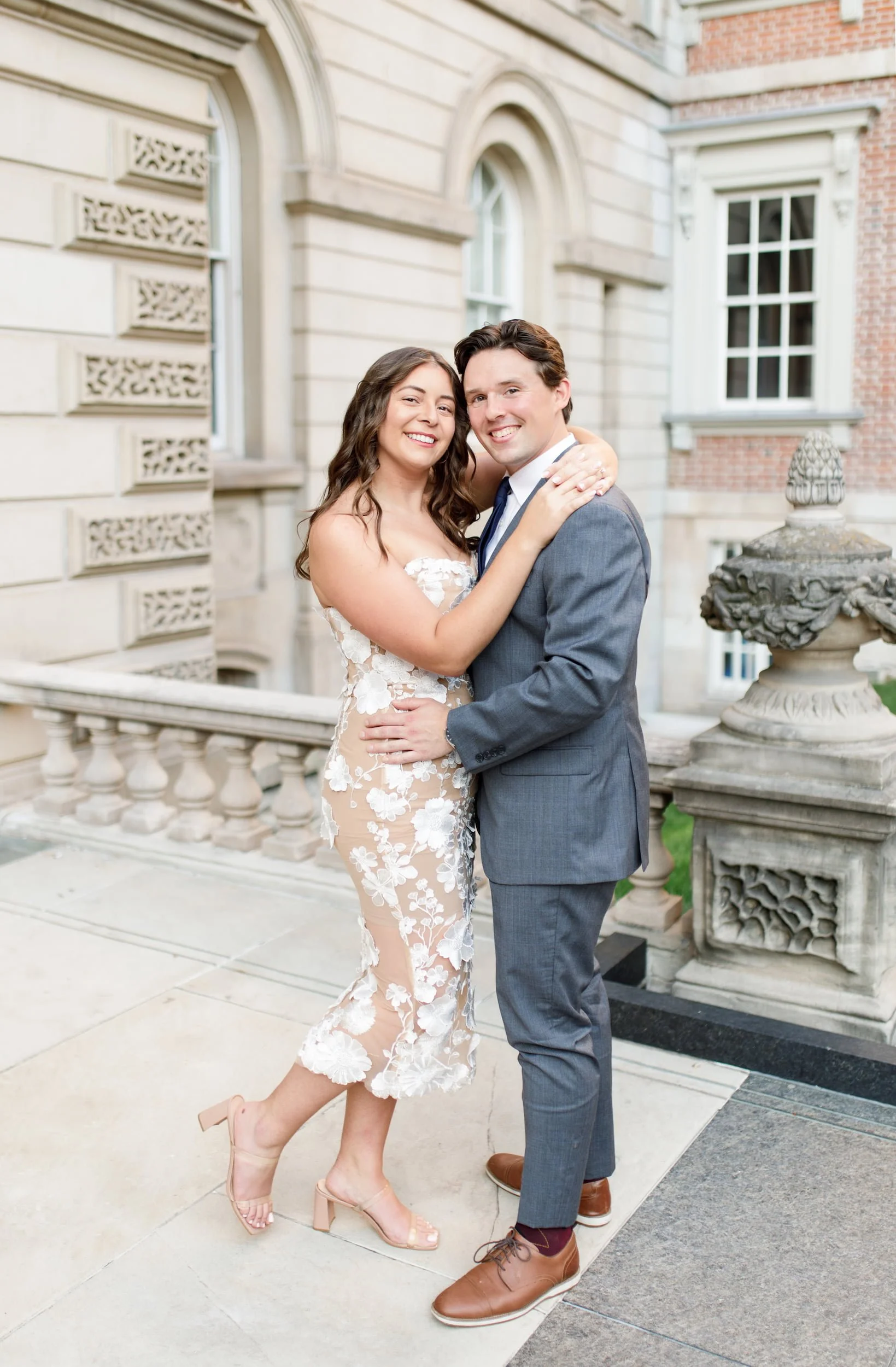 Couple portrait beside historic limestone detailing at Osgoode Hall courthouse in Toronto