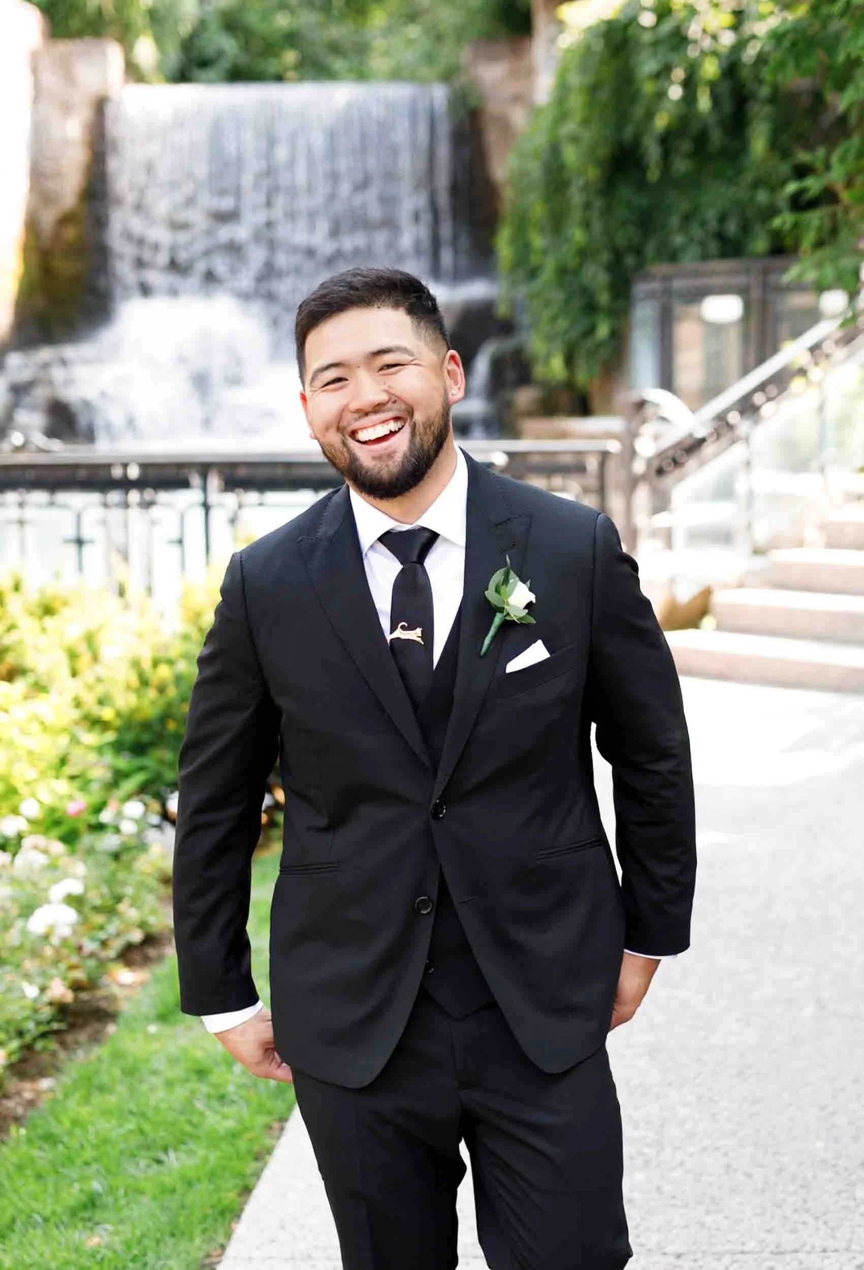 Groom portrait near the waterfall at the Ancaster Mill in Ancaster, Ontario