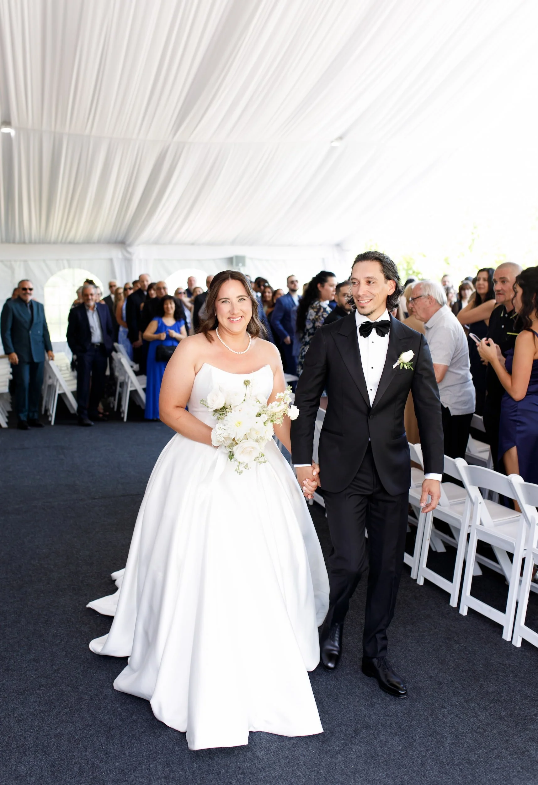 Bride and groom walking back down the aisle after ceremony at The Manor Event Venue wedding in King, Ontario