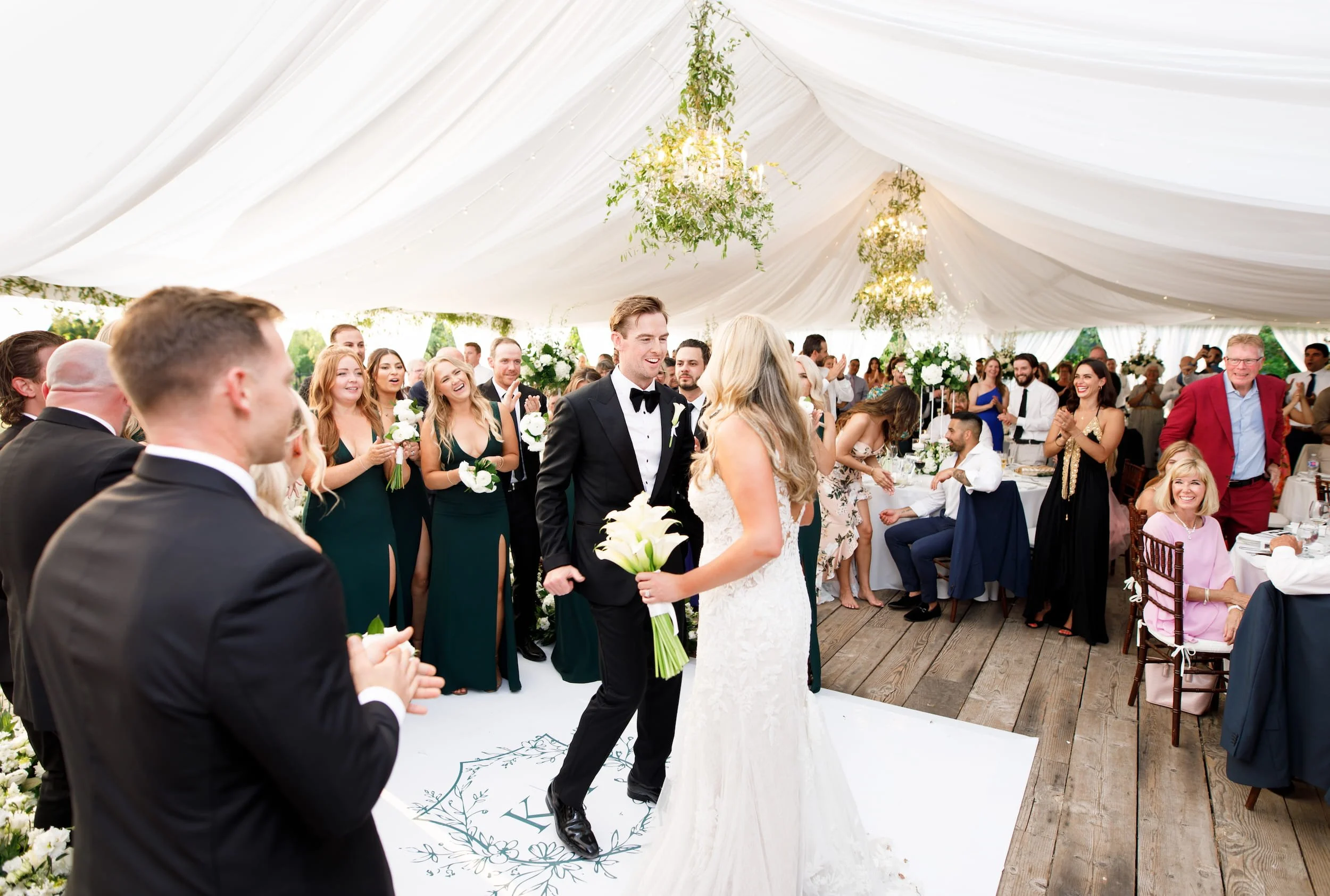 Bride and groom grand entrance inside tented reception at Kurtz Orchards