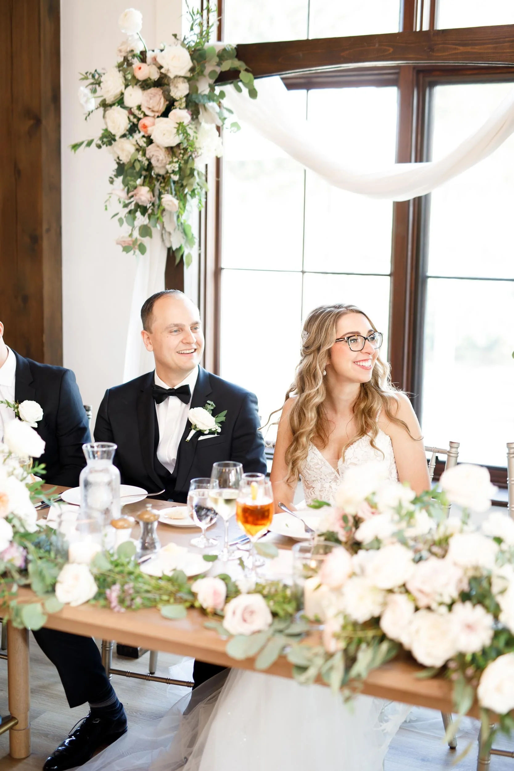 Sweetheart table moment at Whistle Bear Golf Club wedding reception in Cambridge, Ontario