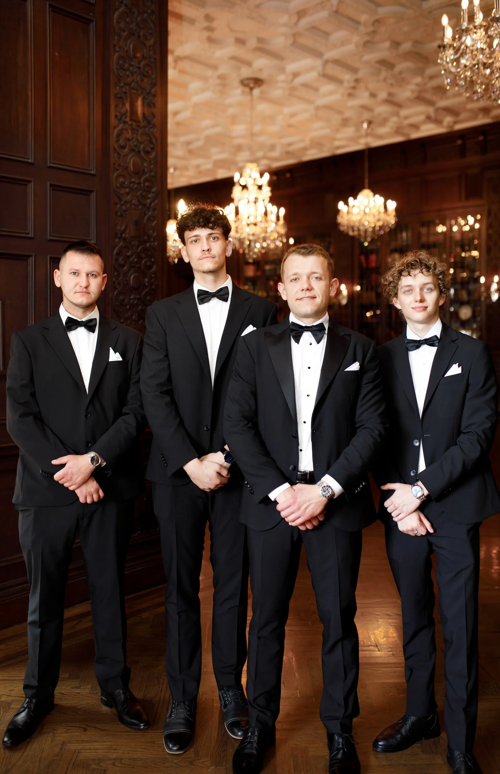 Groomsmen portrait inside Casa Loma’s chandelier-lit interior