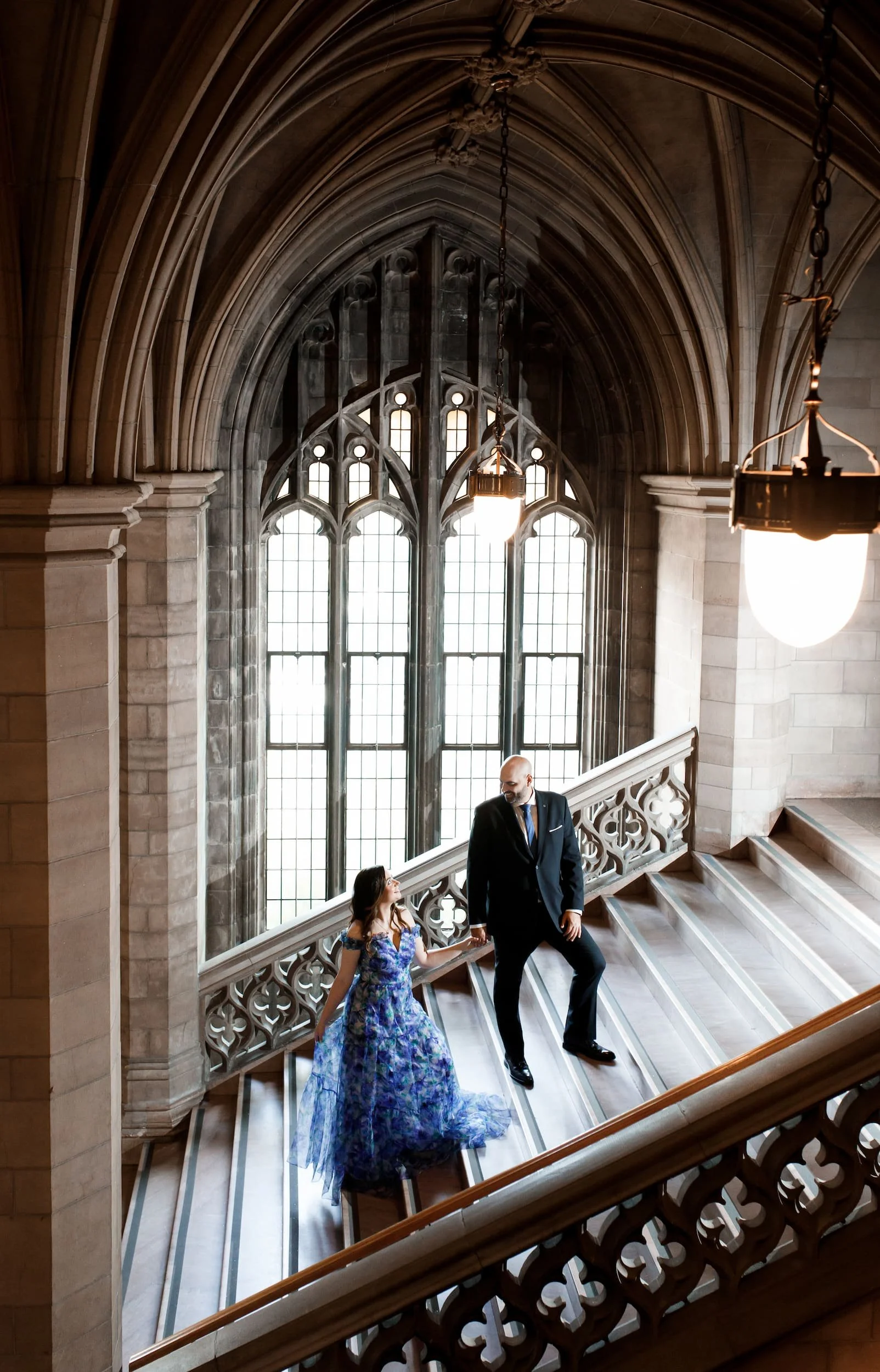 Couple on the grand staircase at Knox College in the University of Toronto