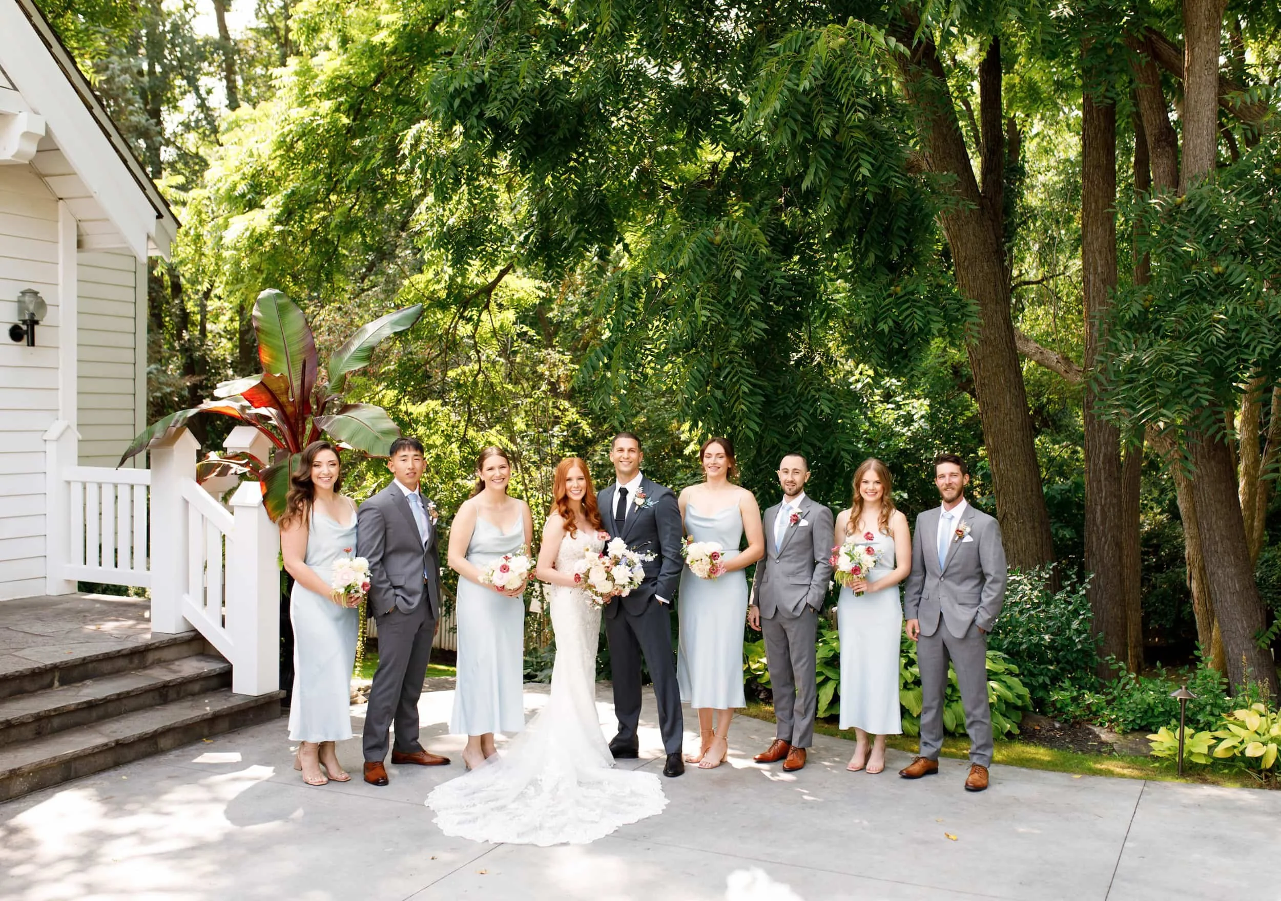 Wedding party portrait beneath trees at The Doctor’s House in Kleinburg, Ontario