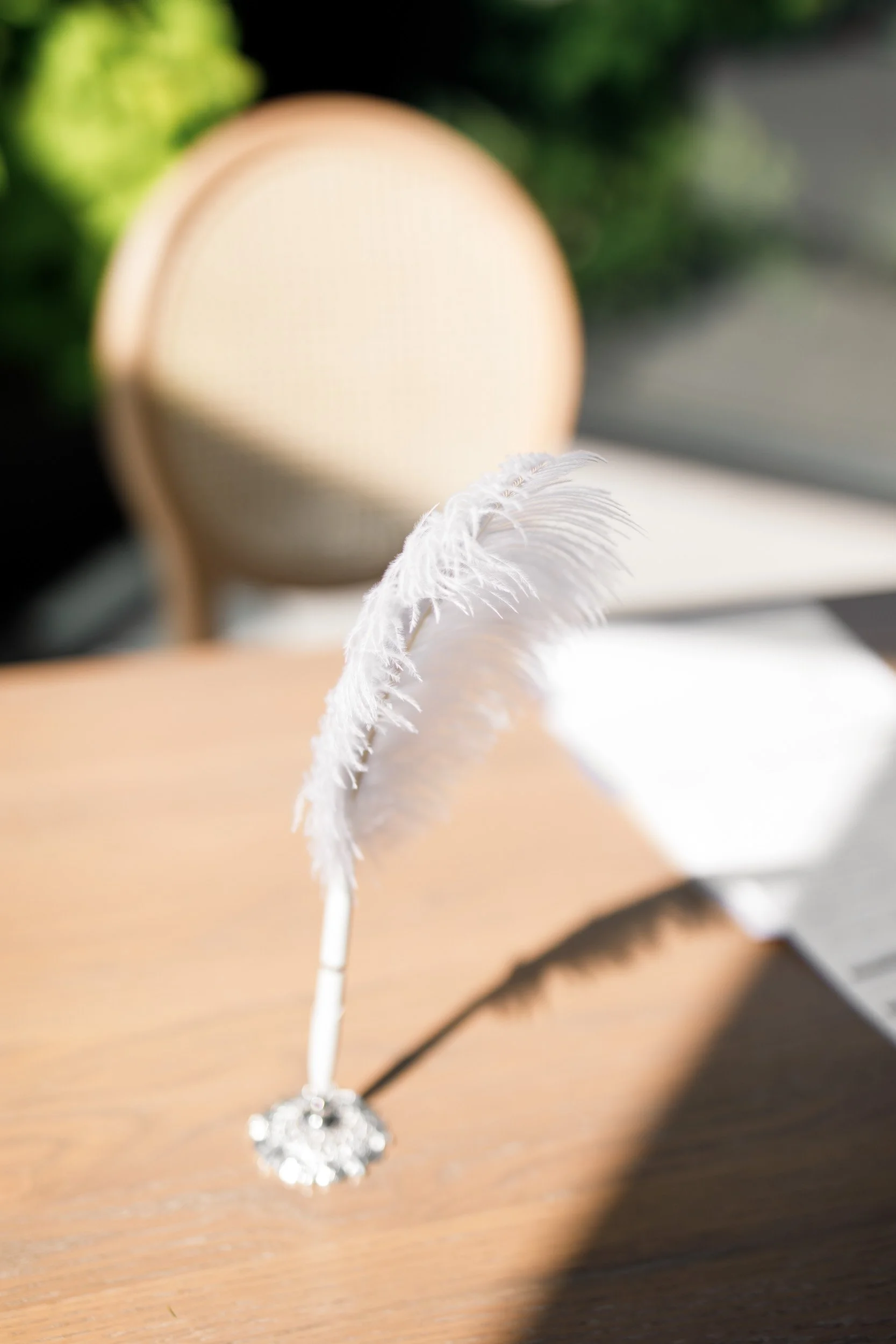 Close-up detail of feather quill on signing table at Whistle Bear Golf Club wedding in Cambridge, Ontario