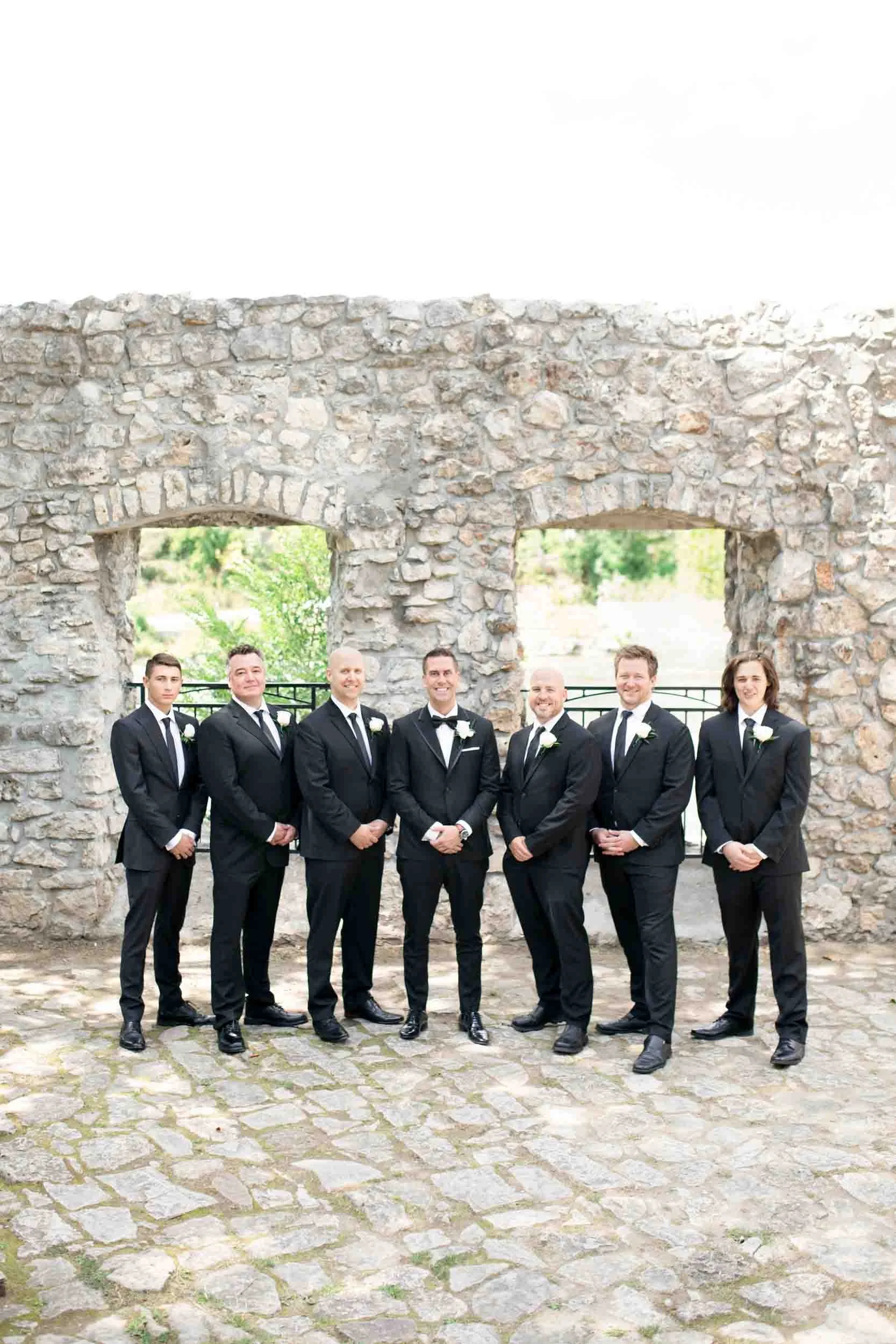 Groomsmen portrait at Mill Race Park historic stone ruins near Cambridge Mill in Cambridge, Ontario