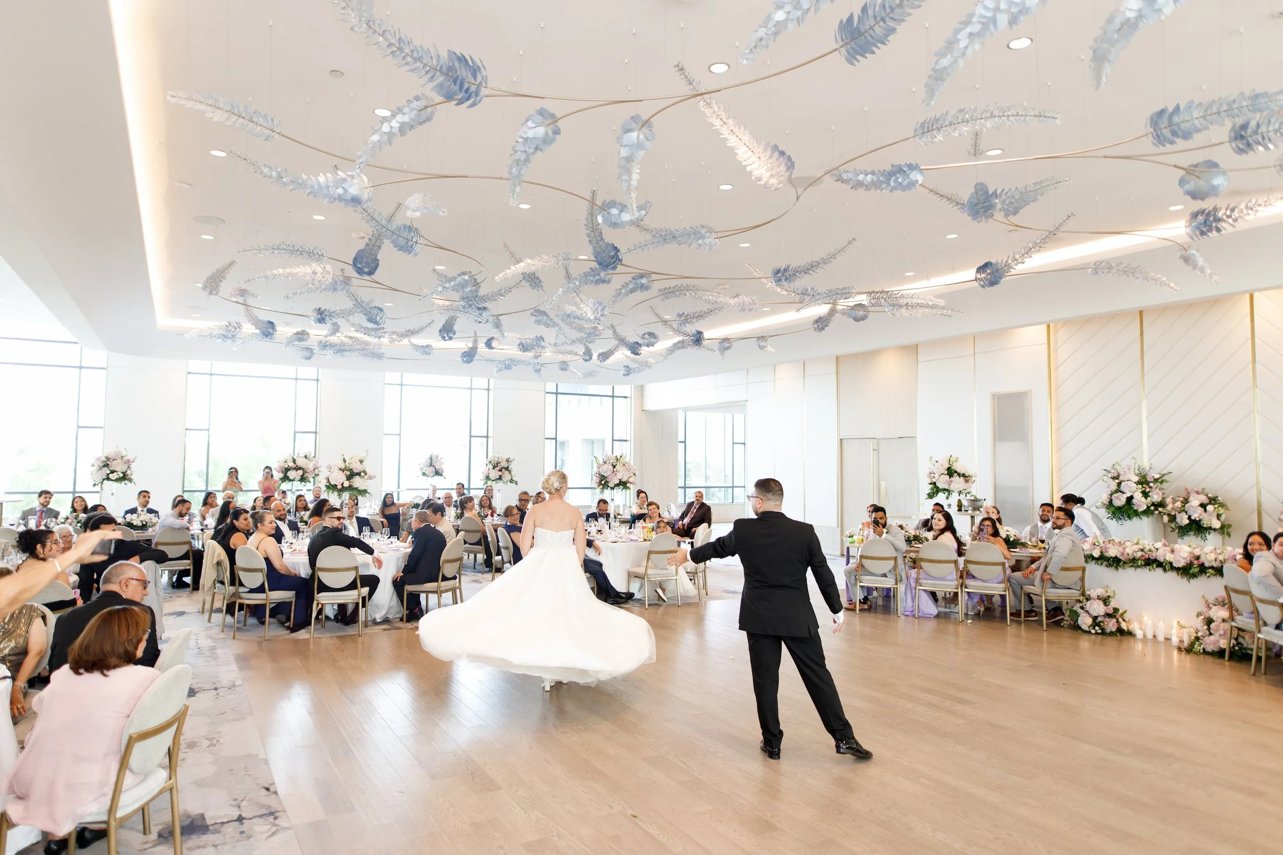 First dance beneath modern ceiling installation at The Pearle Hotel wedding in Burlington