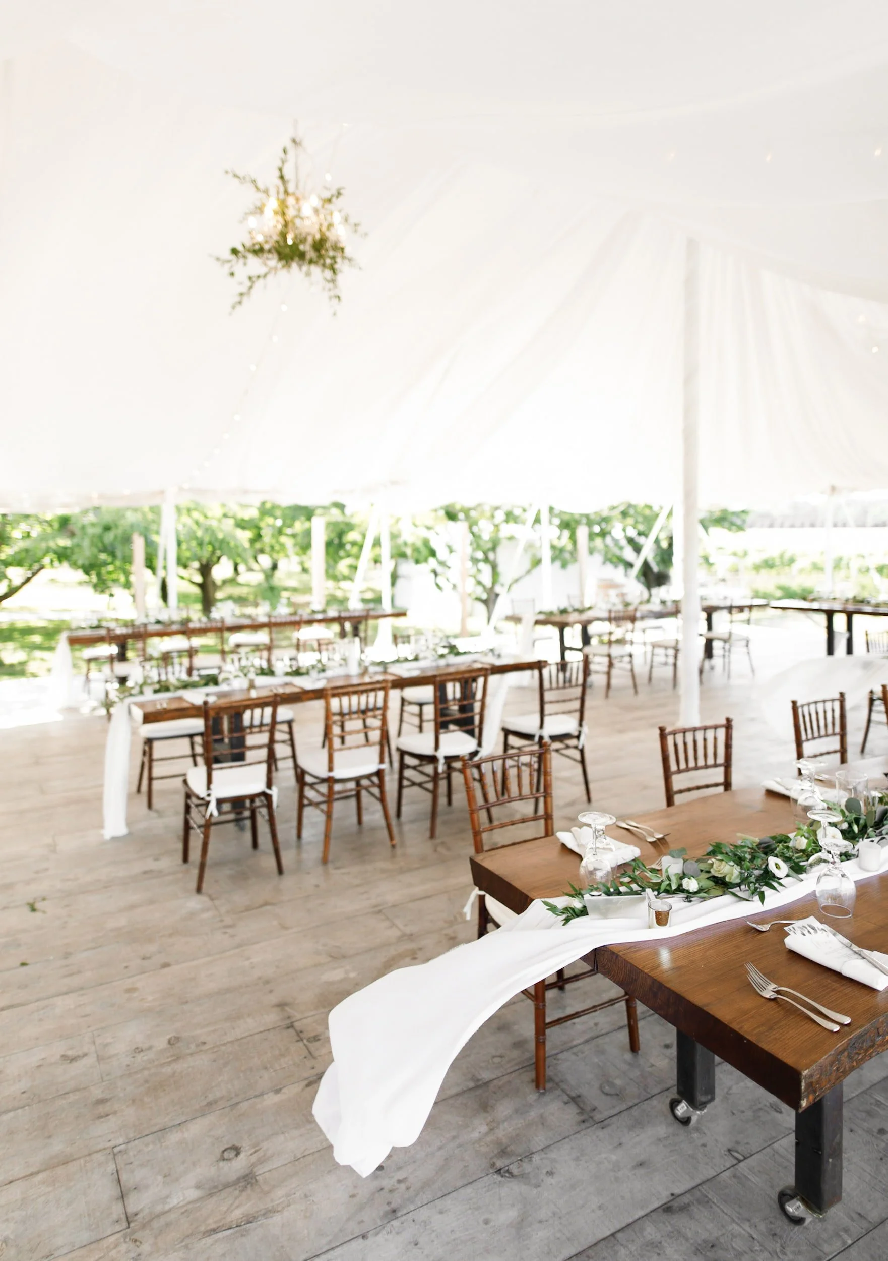 Reception setup beneath white tent at Kurtz Orchards