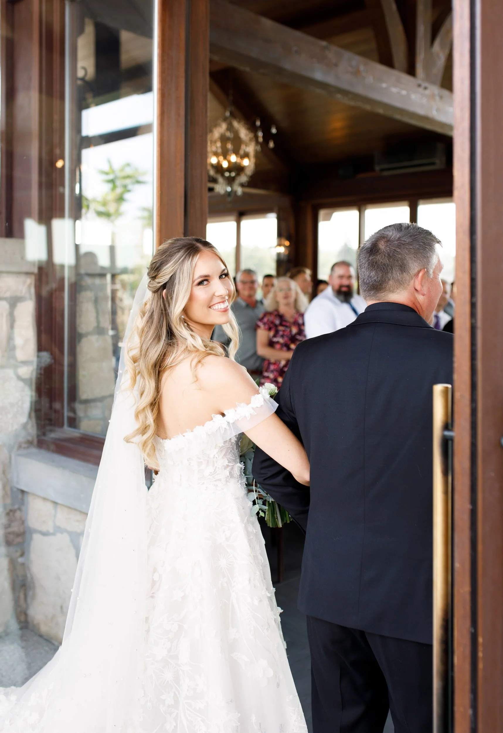 Father of the bride walking his daughter down the aisle during a wedding ceremony at Cambridge Mill in Cambridge, Ontario