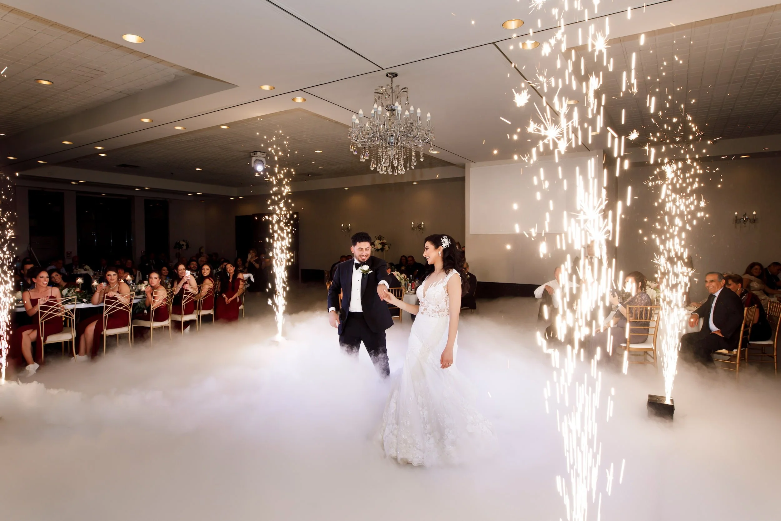 Grand entrance with sparkler effects under chandelier at The Manor Event Venue in King, Ontario