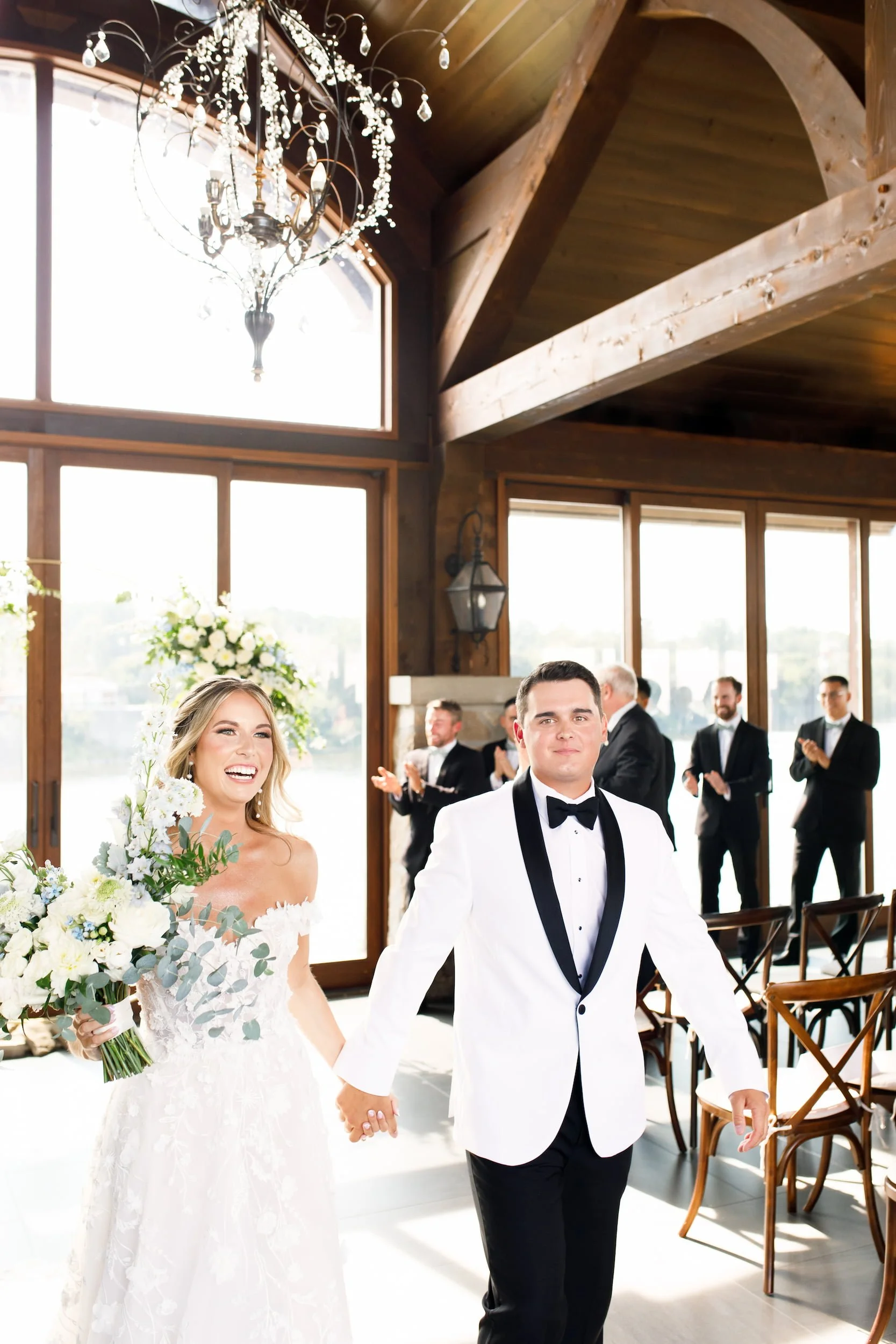 Bride and groom walking down the aisle after their wedding ceremony at Cambridge Mill in Cambridge, Ontario