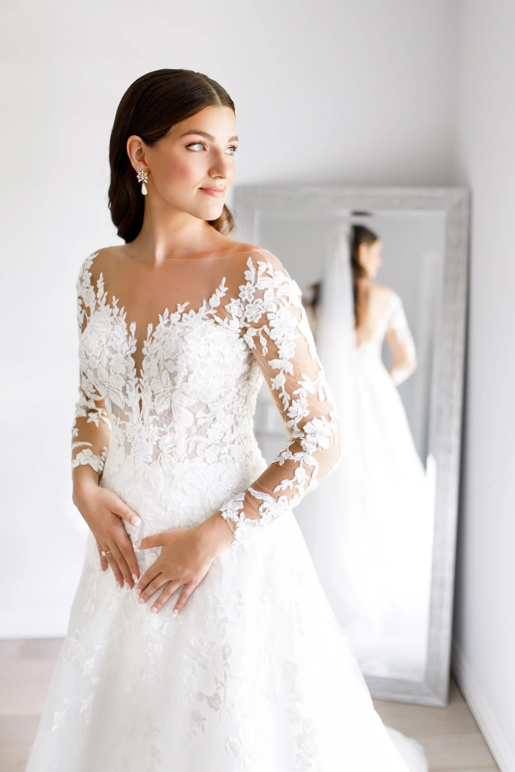 Bride in a lace wedding gown during indoor bridal portraits in St. Catharines, Niagara Region wedding