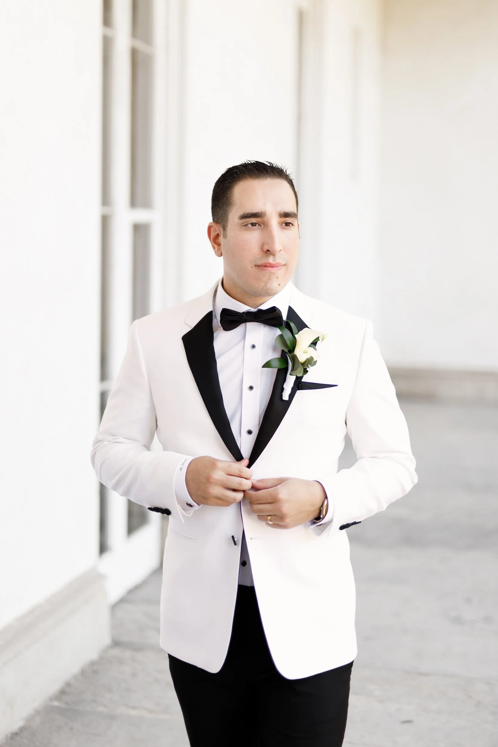 Groom portrait in white tuxedo at Dundurn Castle