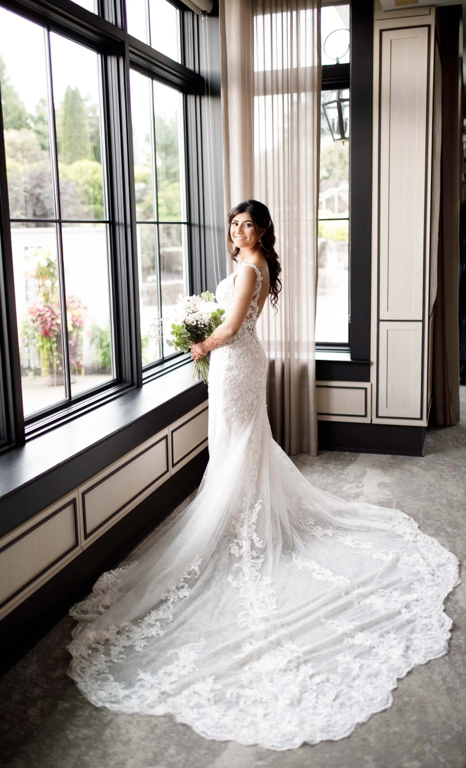 Bridal portrait by large window at Whistle Bear Golf Club in Cambridge, Ontario