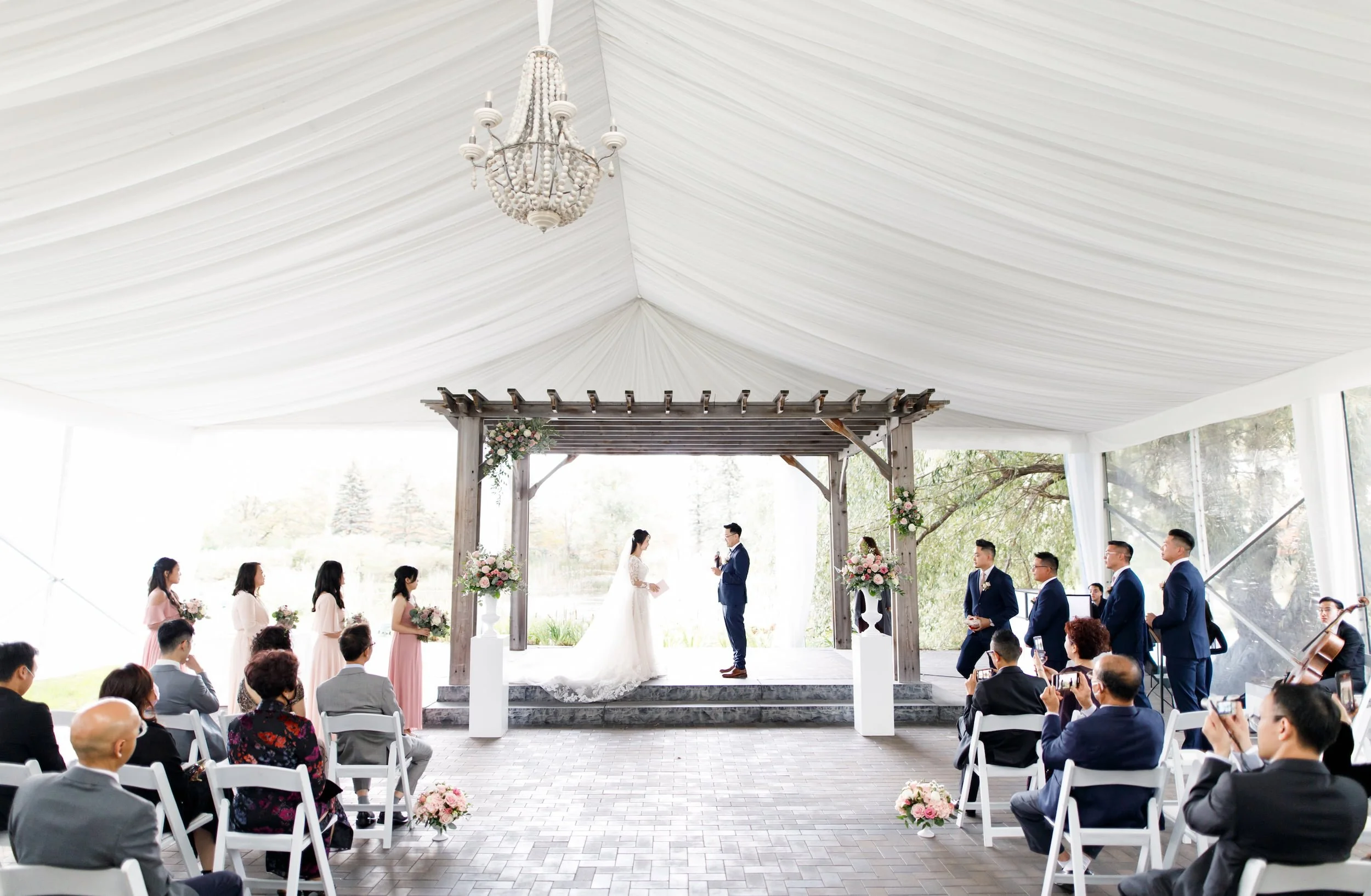 Outdoor while tent wedding ceremony beneath the Arlington Estate white pavilion in Vaughan