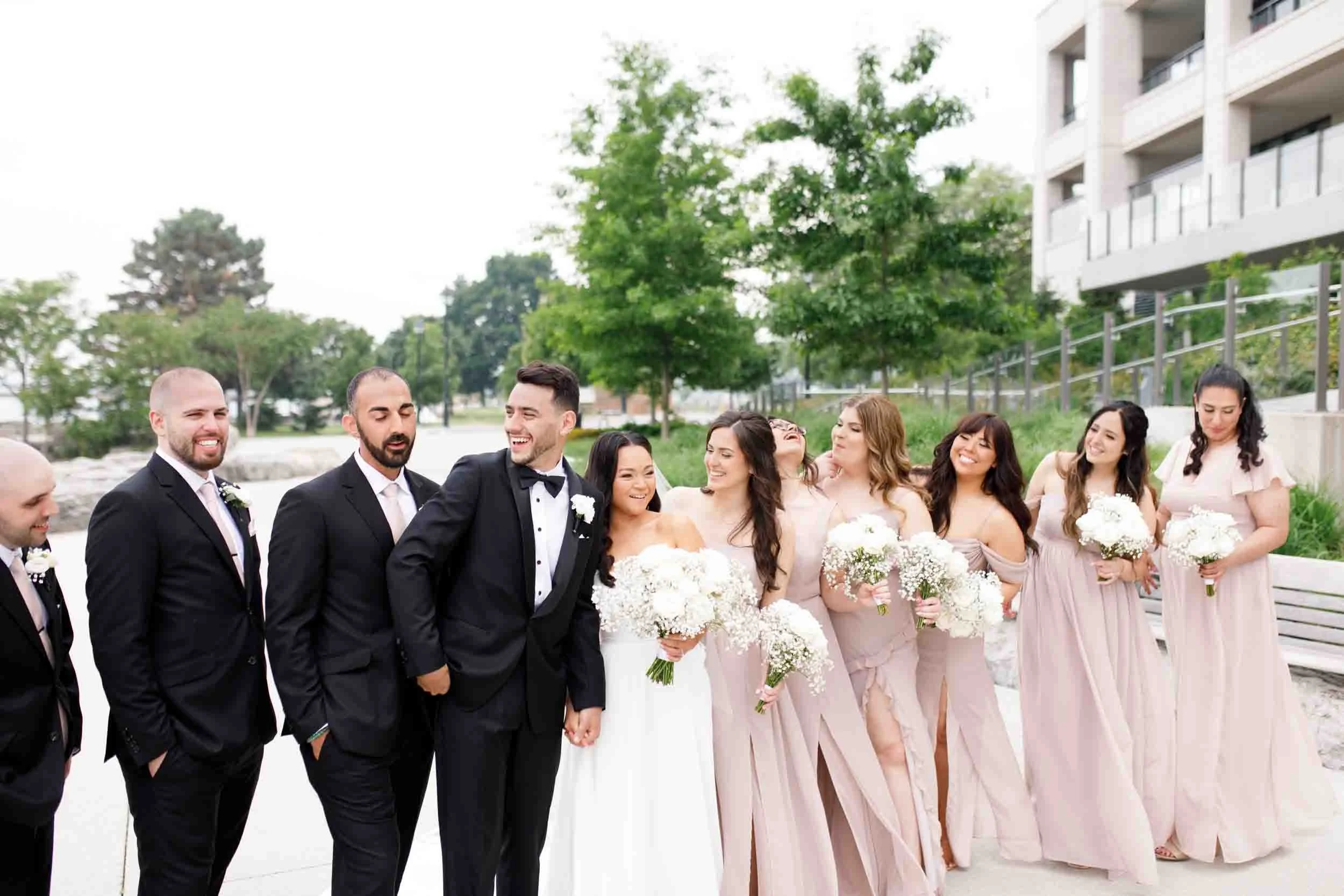 Wedding party walking along Burlington waterfront near The Pearle Hotel & Spa