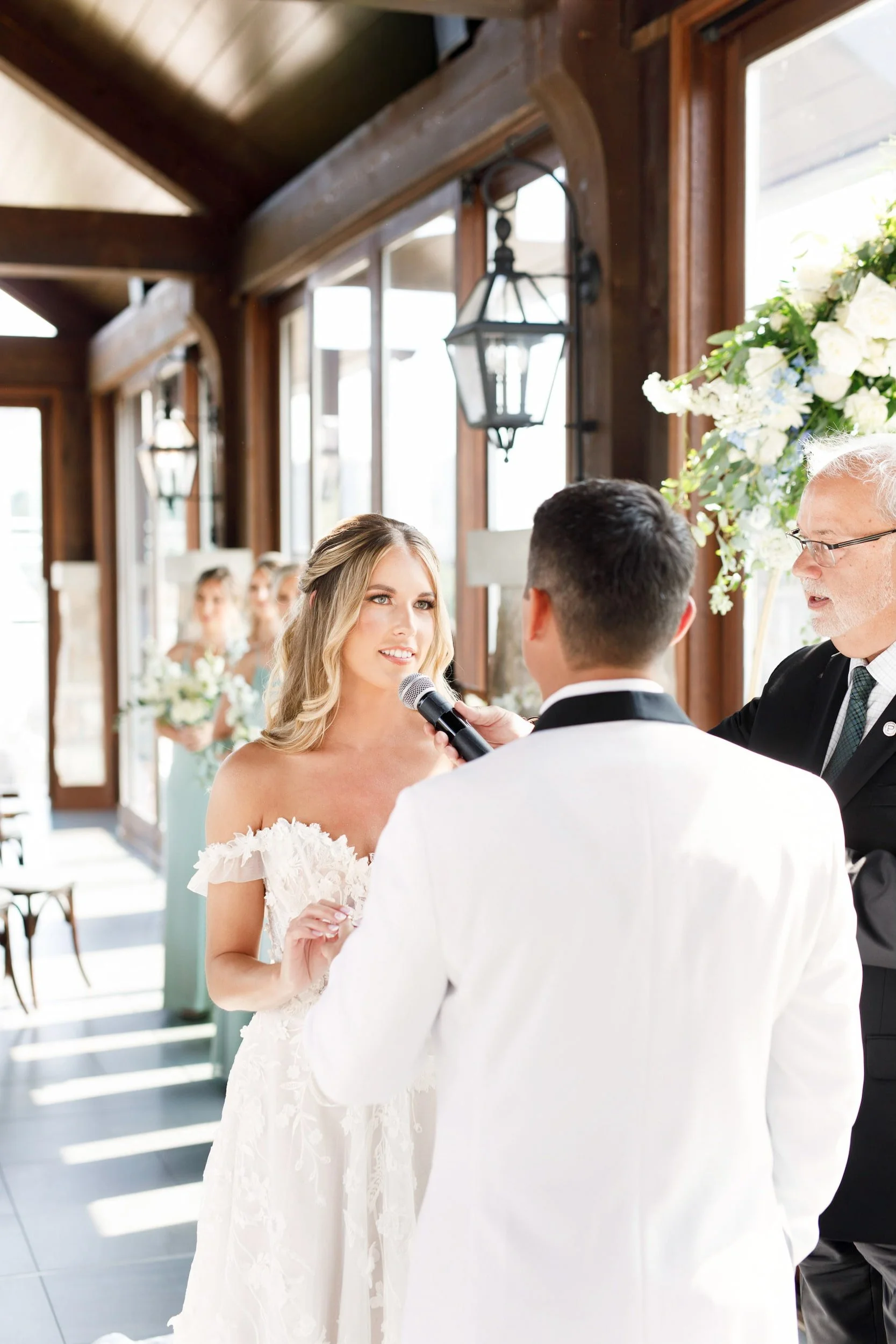 Bride exchanging vows inside Cambridge Mill ceremony space with river views