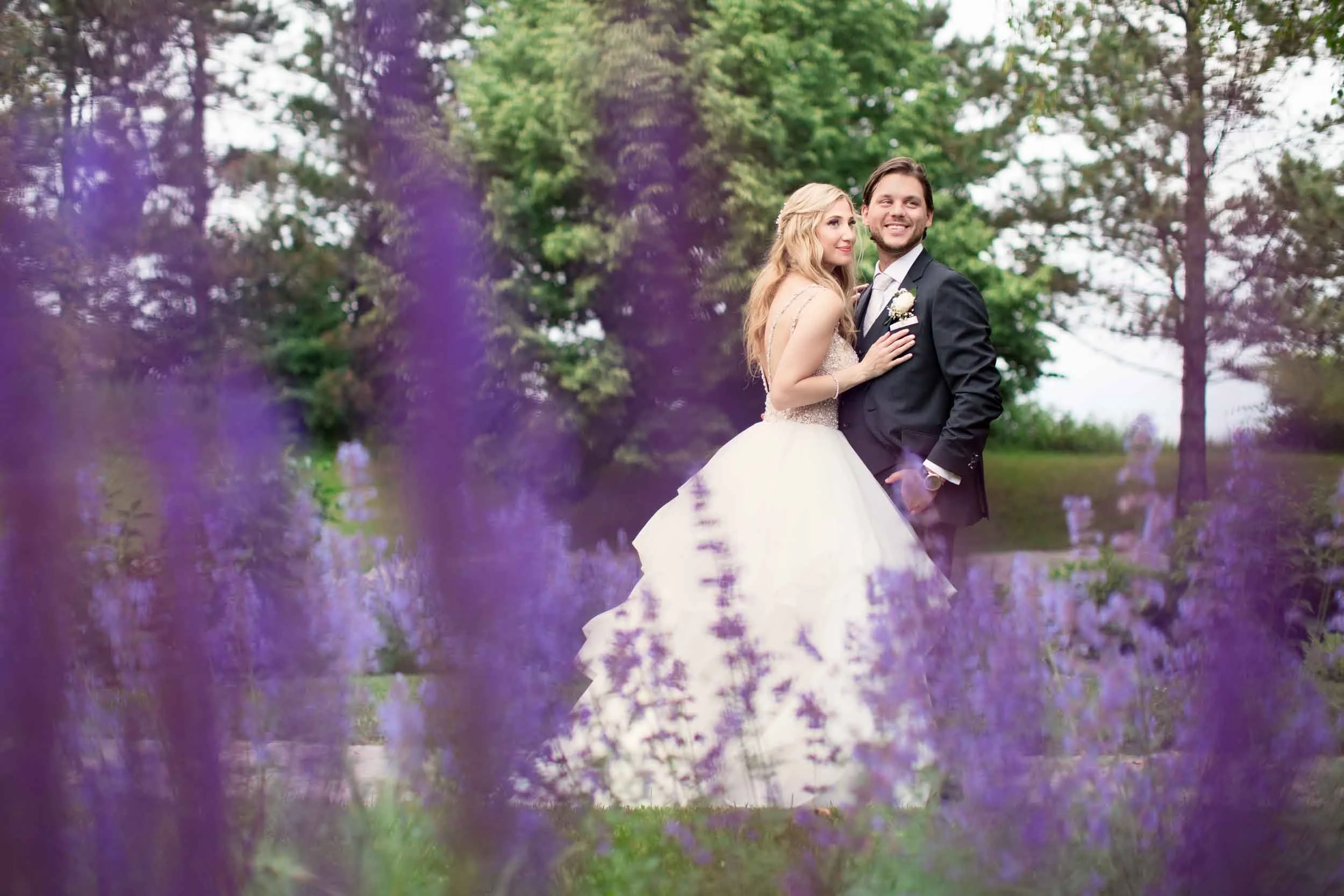 Bride and groom embracing in lavender garden at The Manor Event Venue wedding in King, Ontario