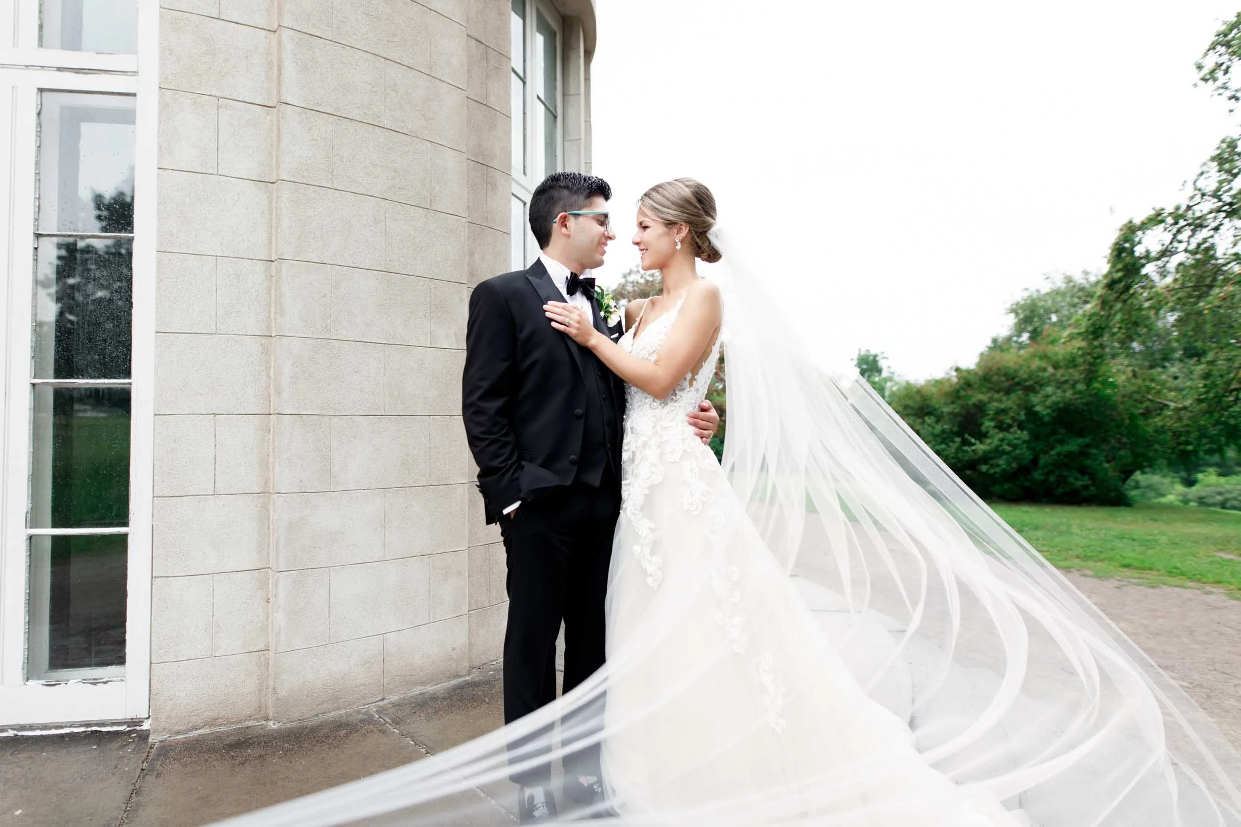 Bride and groom portrait against Dundurn Castle stone exterior