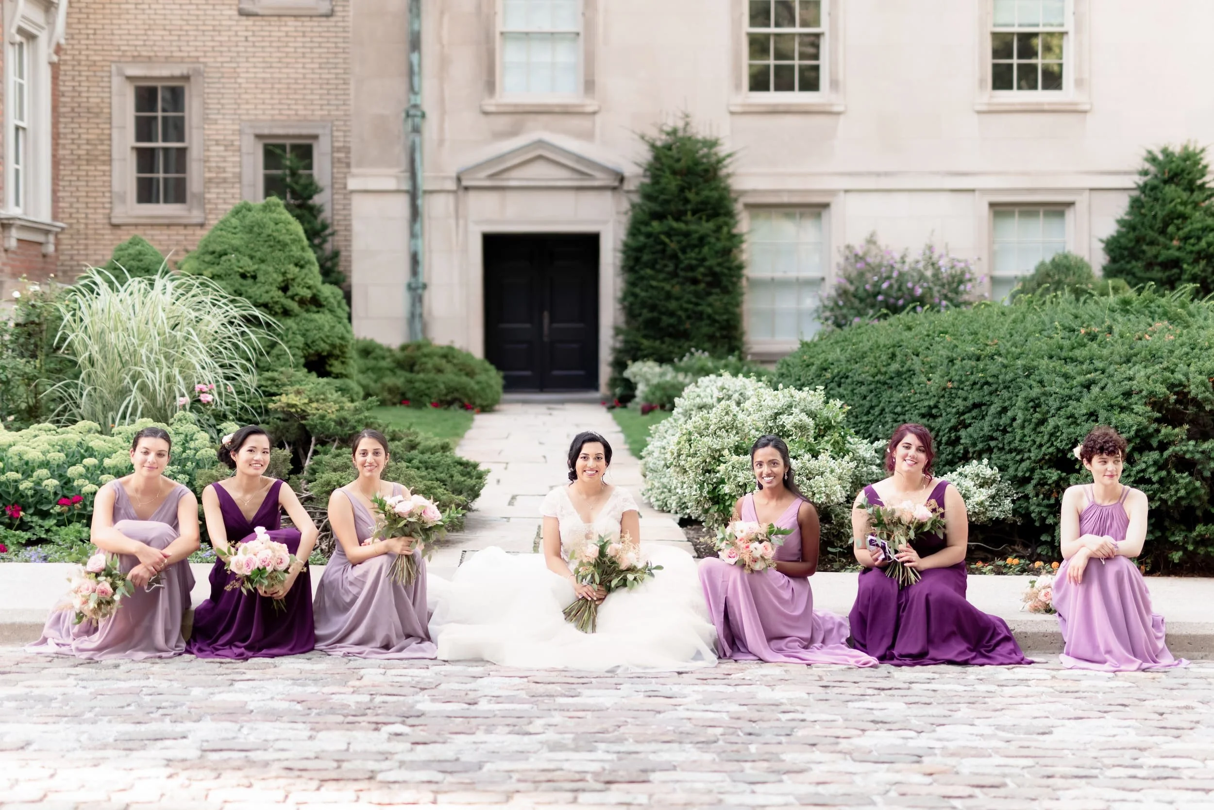 Wedding party seated in historic courtyard at Osgoode Hall courthouse