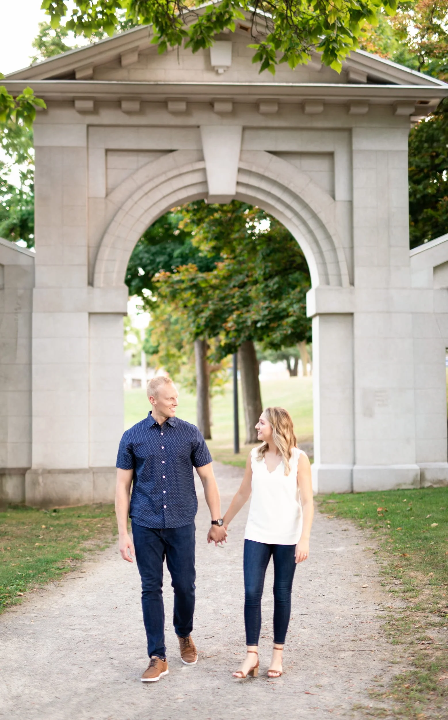Engagement session beneath Dundurn Castle stone archway