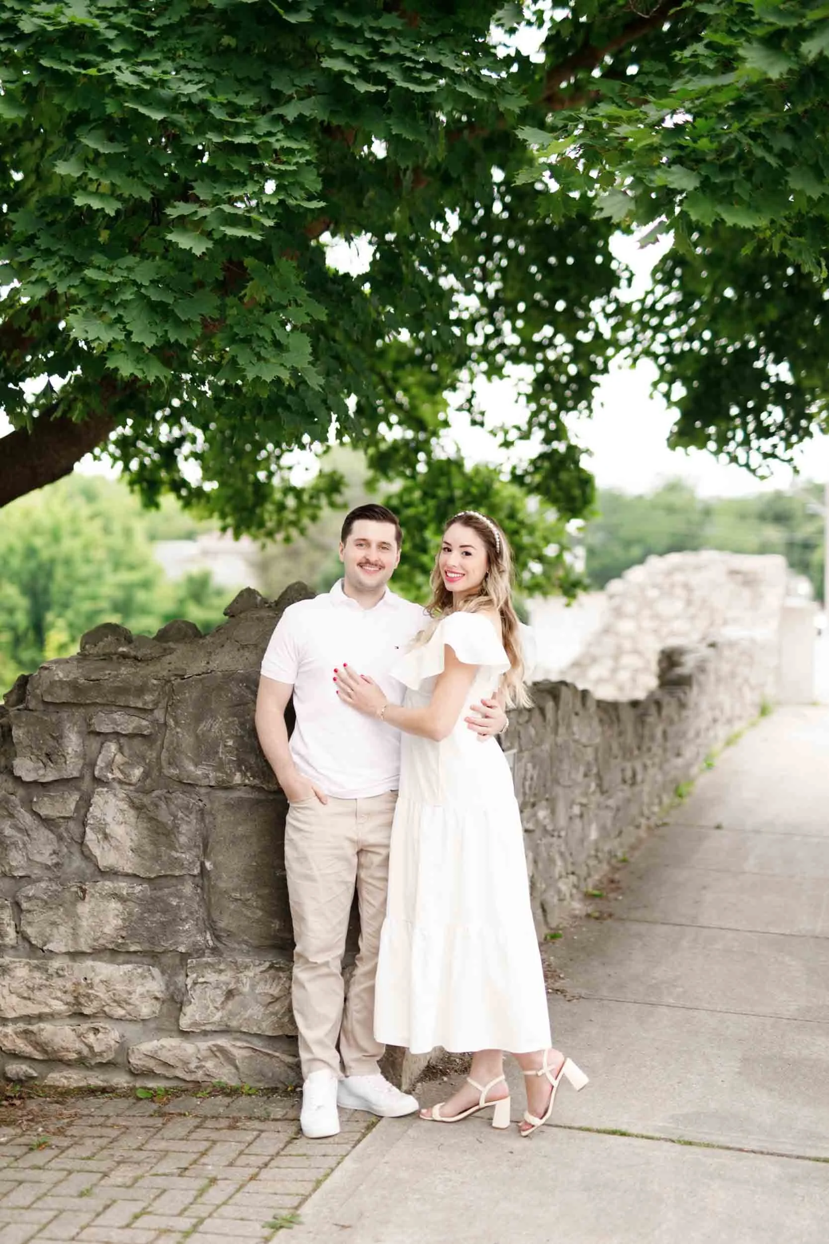 Engagement portrait along historic limestone walkway near Cambridge Mill in Cambridge, Ontario
