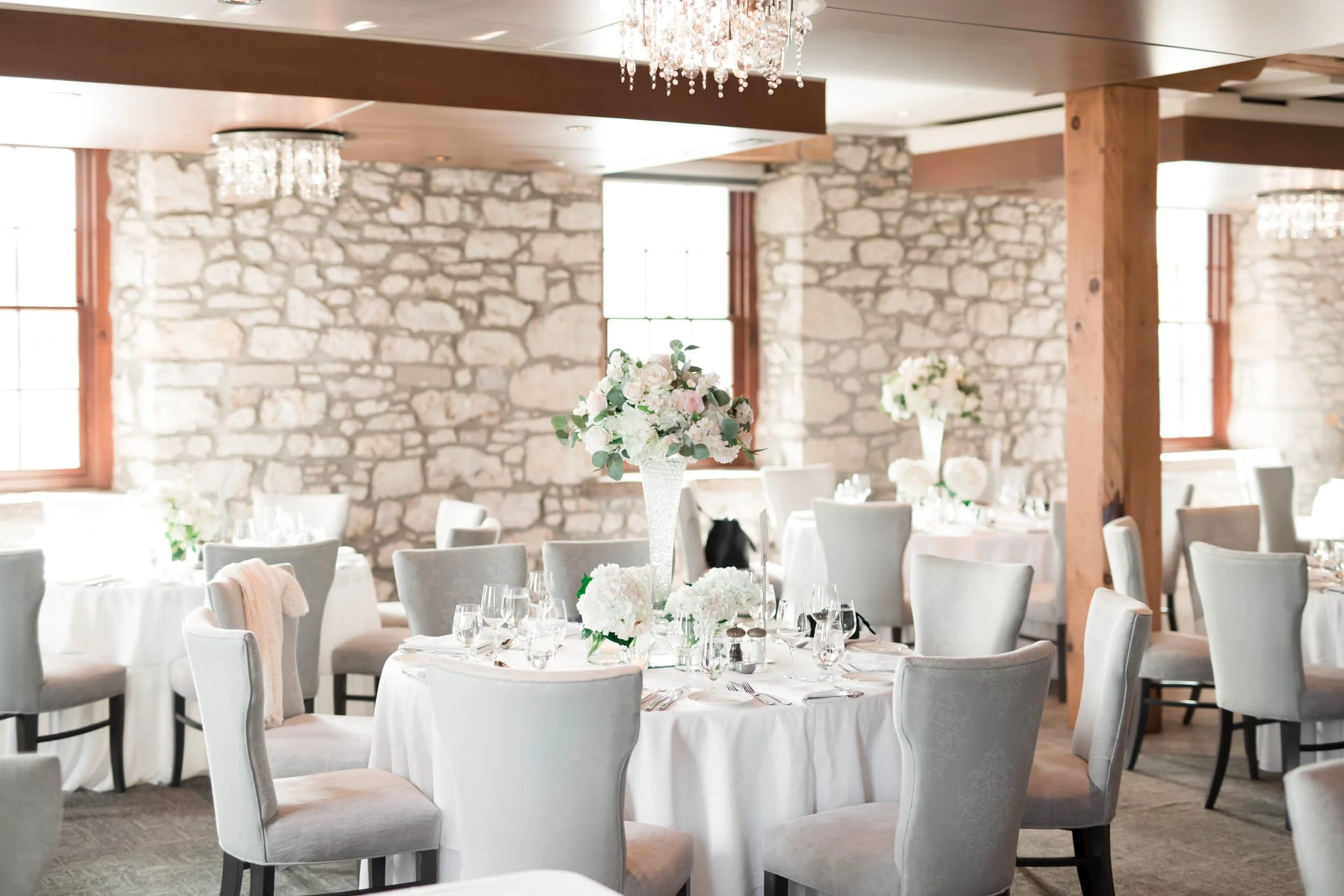 Elegant round table reception setup at Cambridge Mill in Cambridge, Ontario