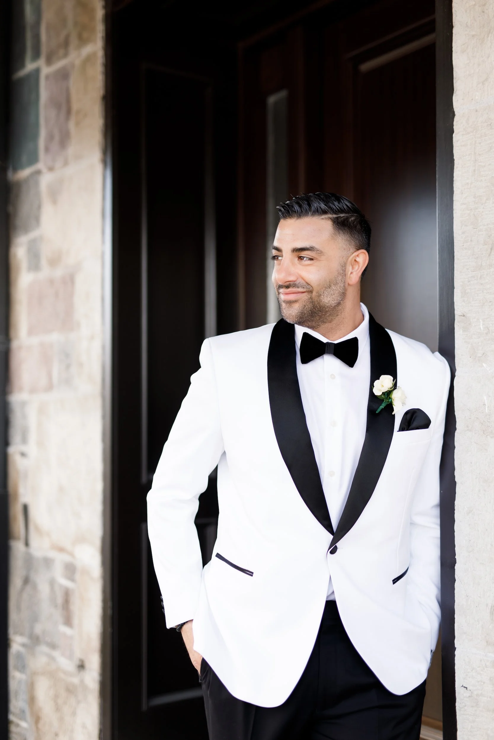 Groom portrait at the Arlington Estate stone entrance in Vaughan