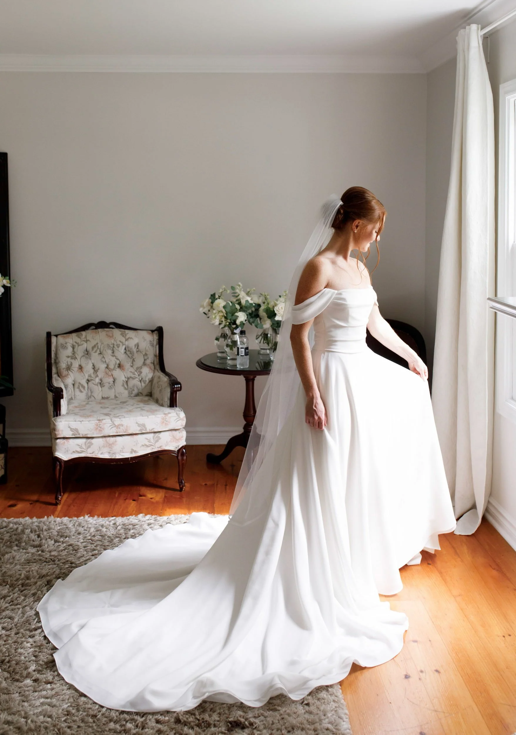Bridal portrait by window in bridal suite heritage cottage at The Doctor’s House in Kleinburg, Ontario