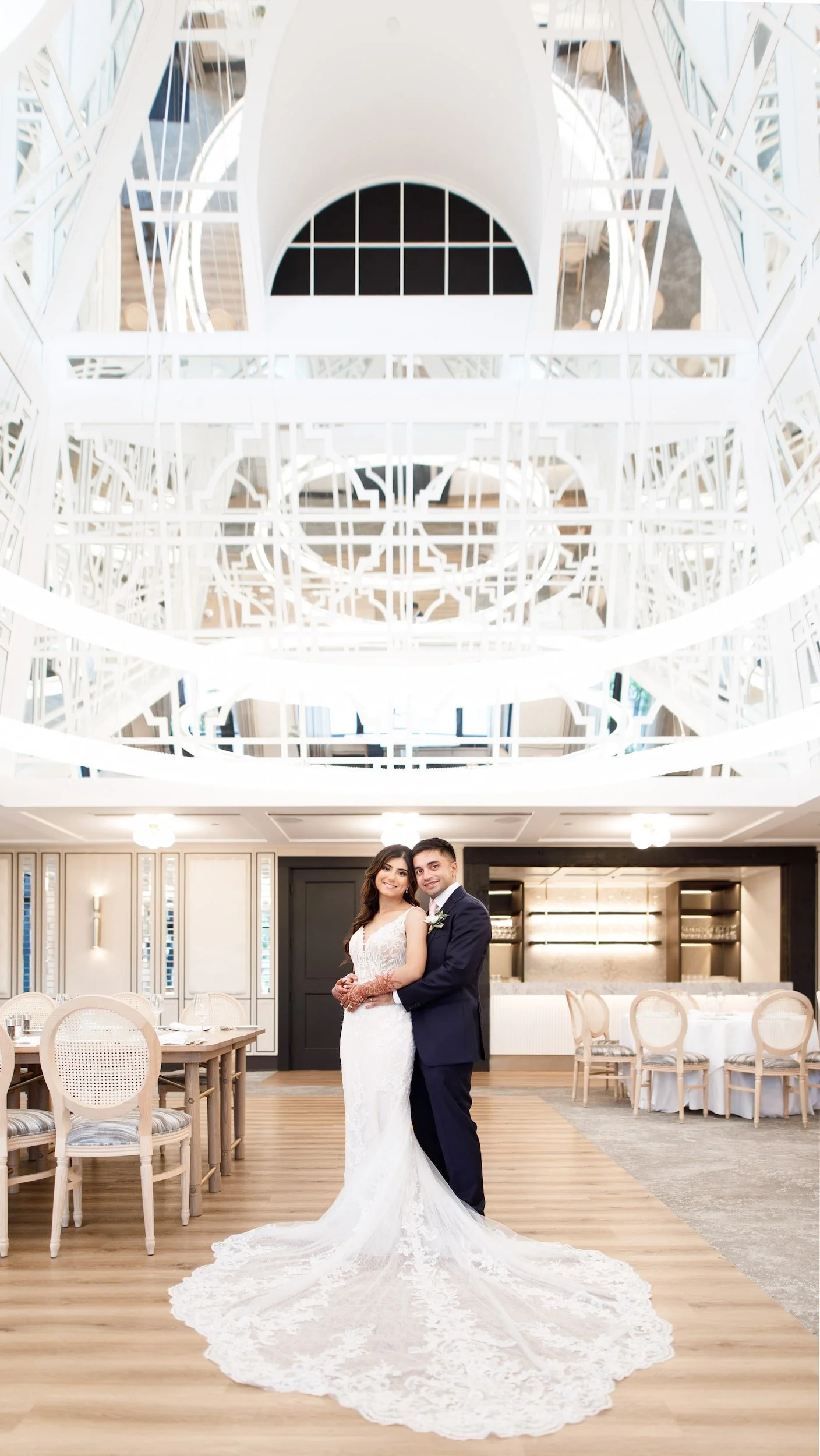 Couple embracing inside modern reception hall at Whistle Bear Golf Club wedding in Cambridge, Ontario