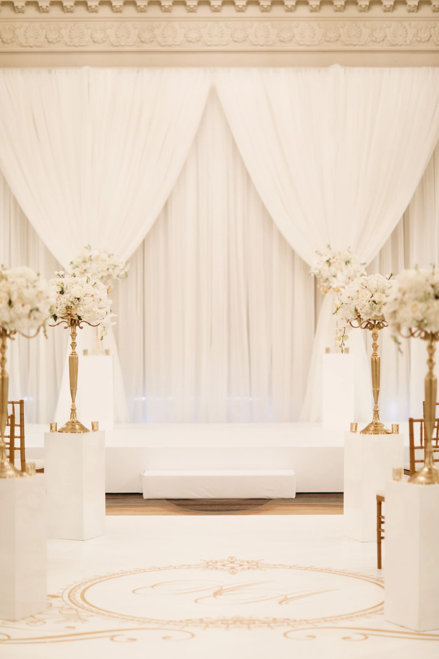 Elegant white ceremony aisle stage setup inside Omni King Edward Hotel Toronto wedding venue