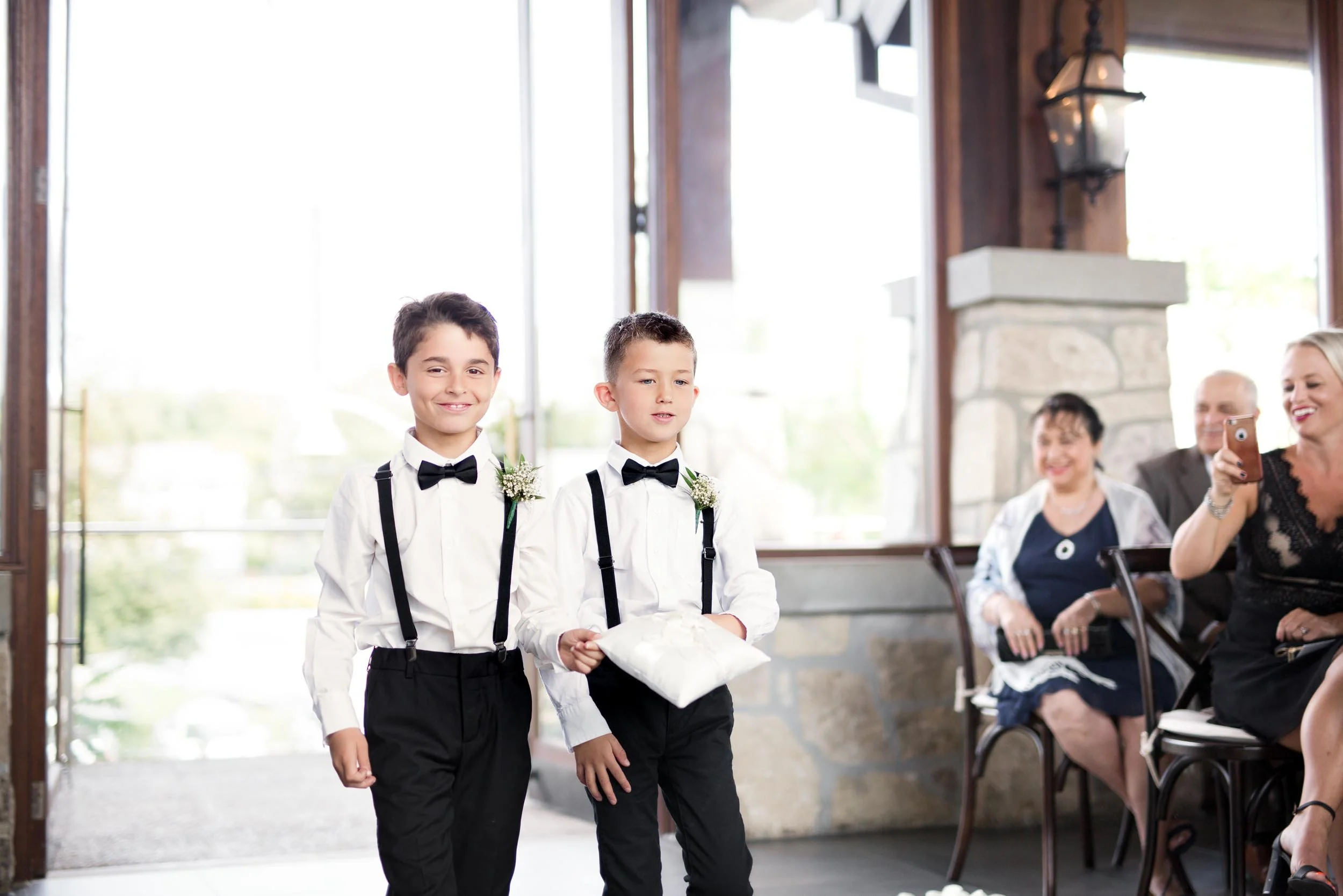 Ring bearers entering ceremony at Cambridge Mill wedding venue in Cambridge, Ontario