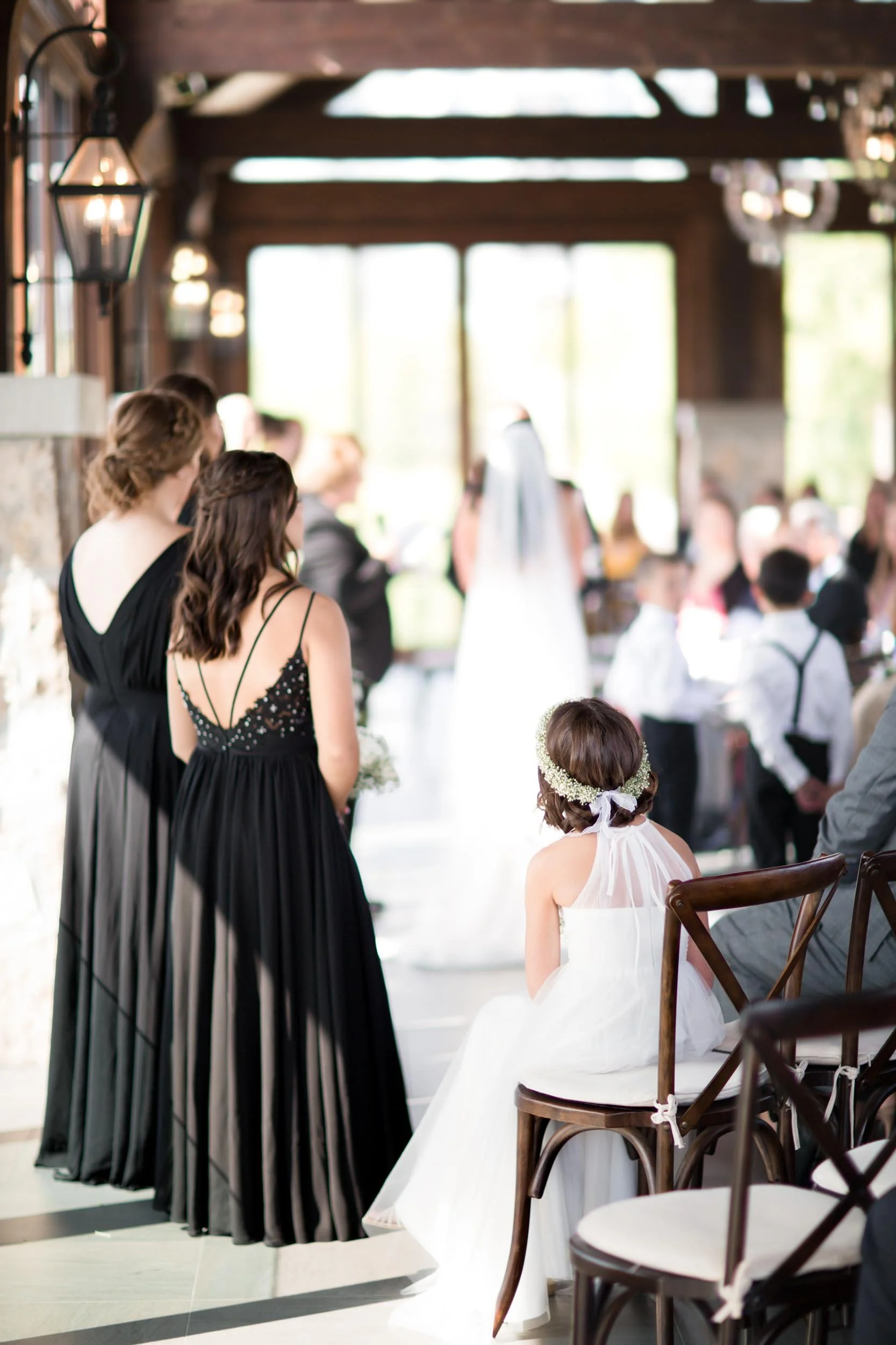 Flower girl at wedding ceremony processional inside Cambridge Mill overlooking the Grand River