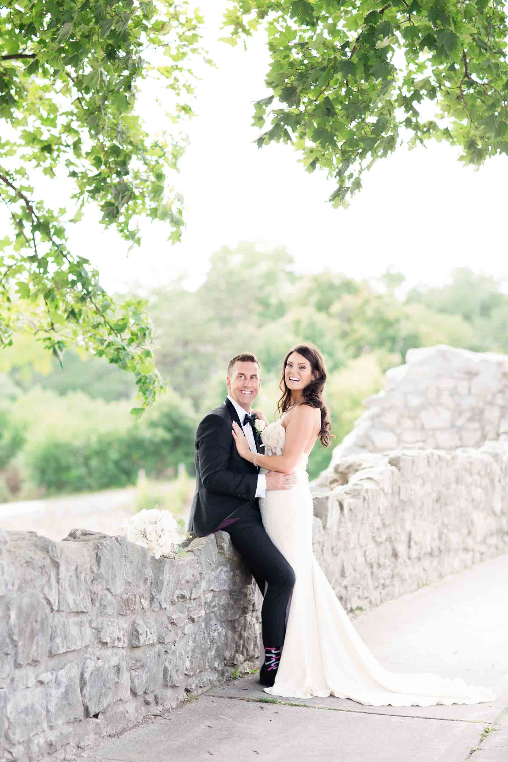 Romantic couple portrait along stone terrace at Cambridge Mill overlooking the Grand River