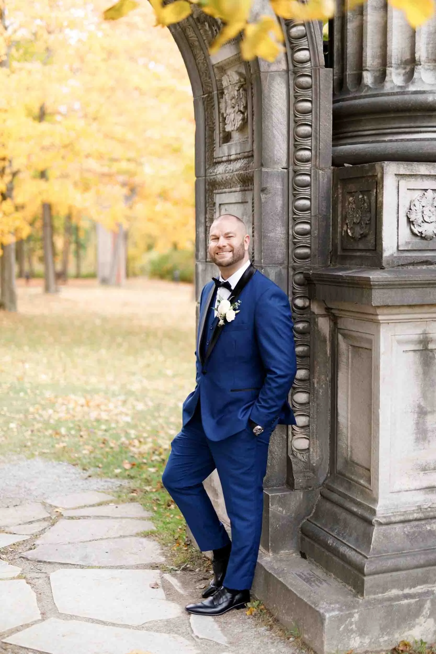 Groom portrait beside historic stone doorway at Guild Inn Estate in Scarborough
