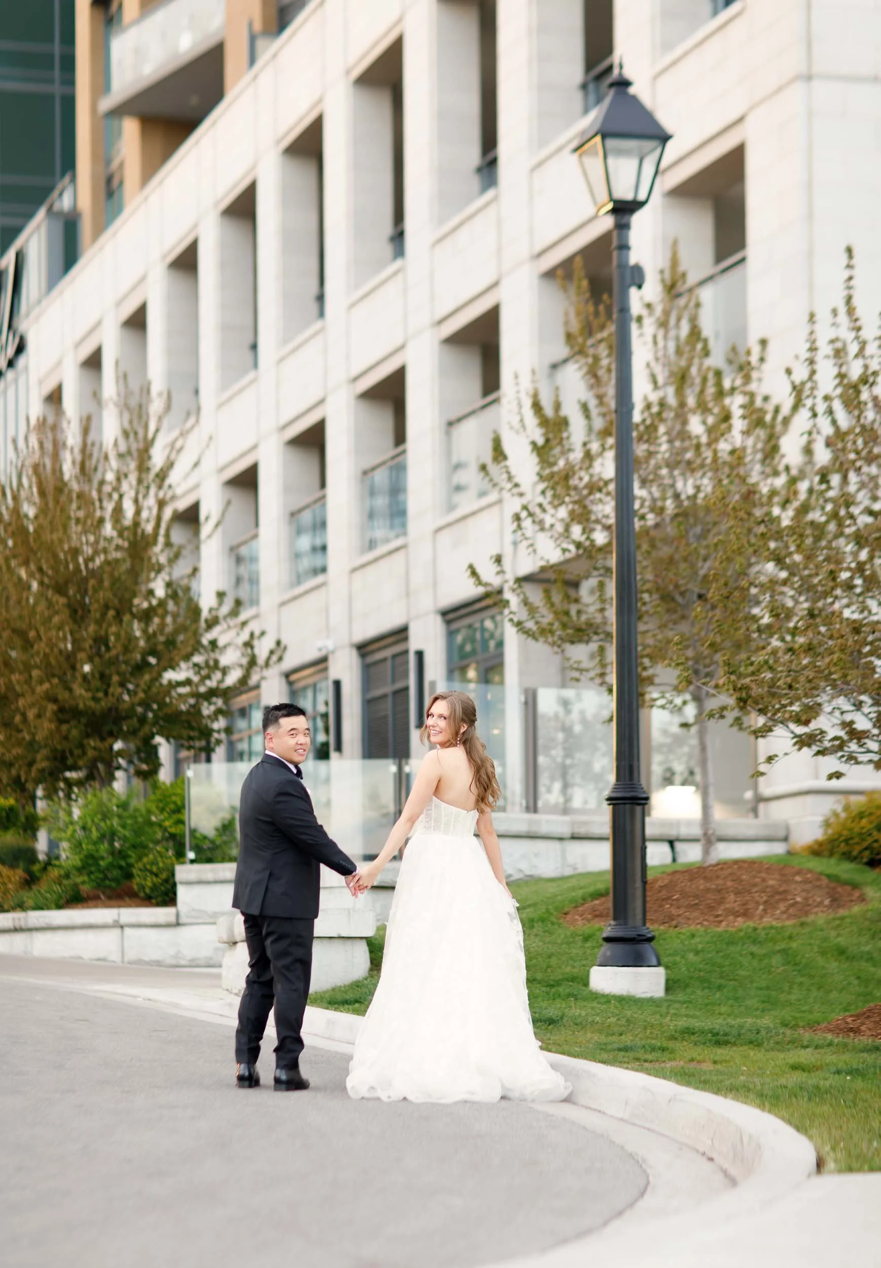 Couple walking outside The Pearle Hotel in downtown Burlington, Ontario
