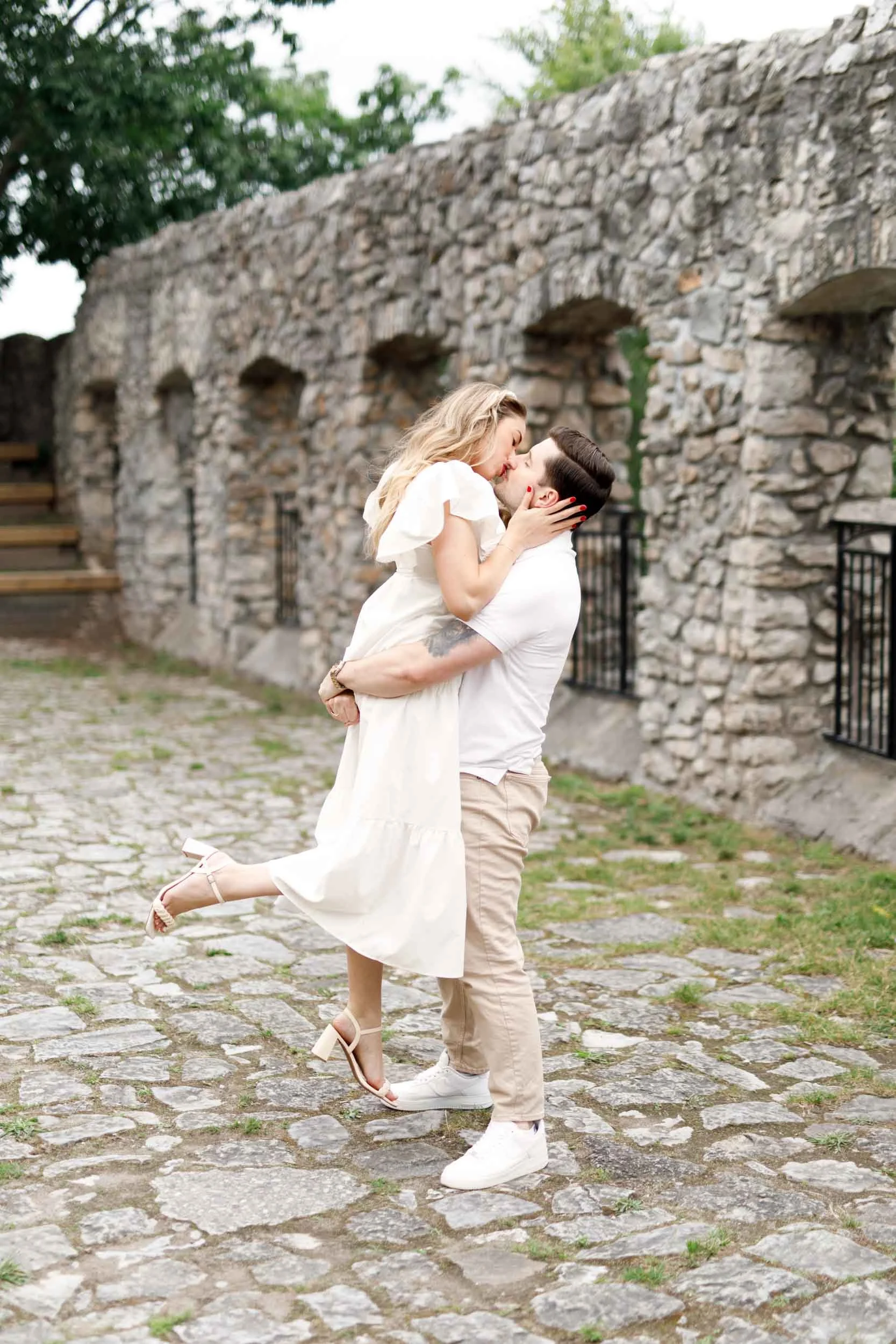 Playful engagement portrait in limestone courtyard near Cambridge Mill, Cambridge Ontario