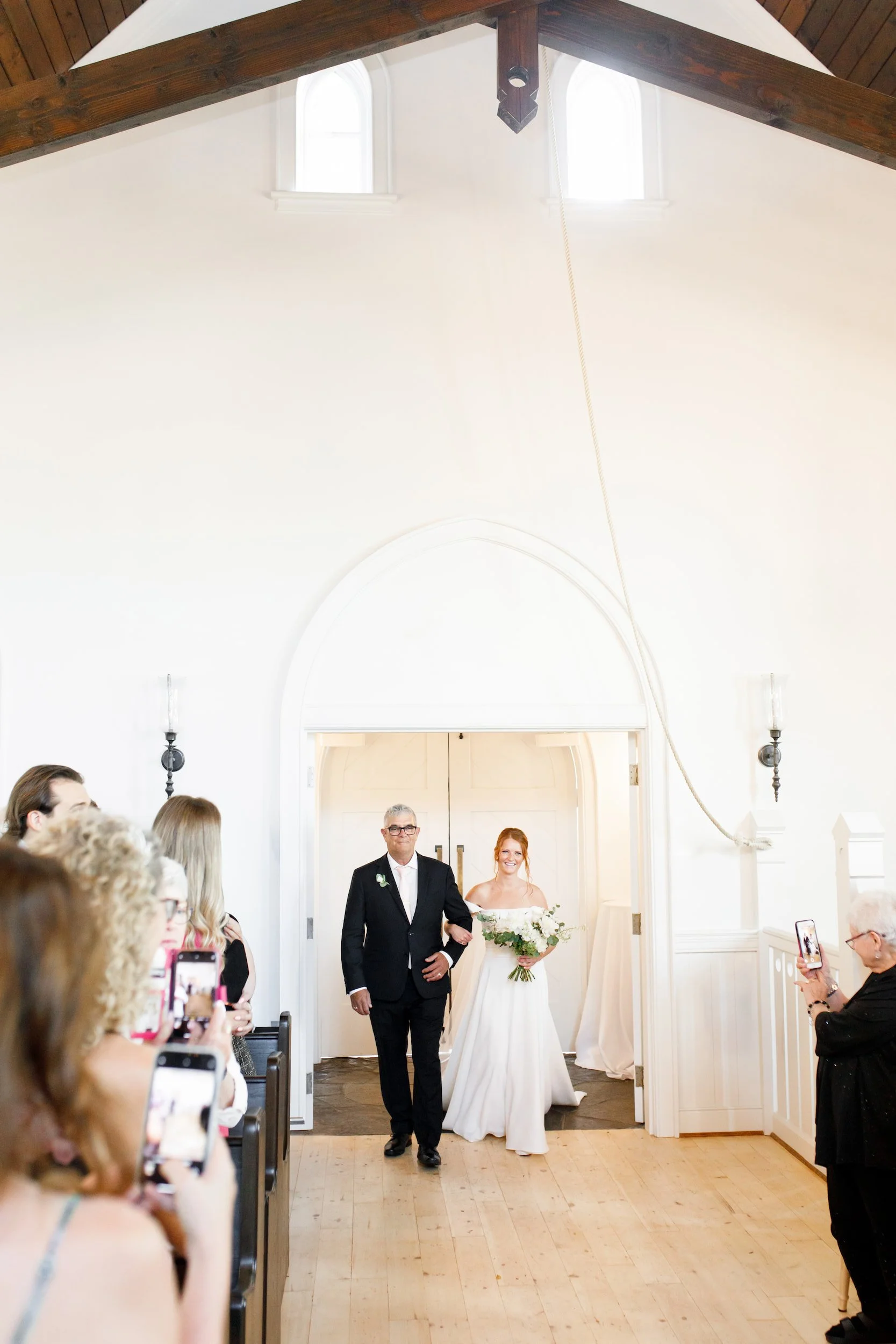 Bride walking down aisle inside chapel at The Doctor’s House wedding in Kleinburg, Ontario