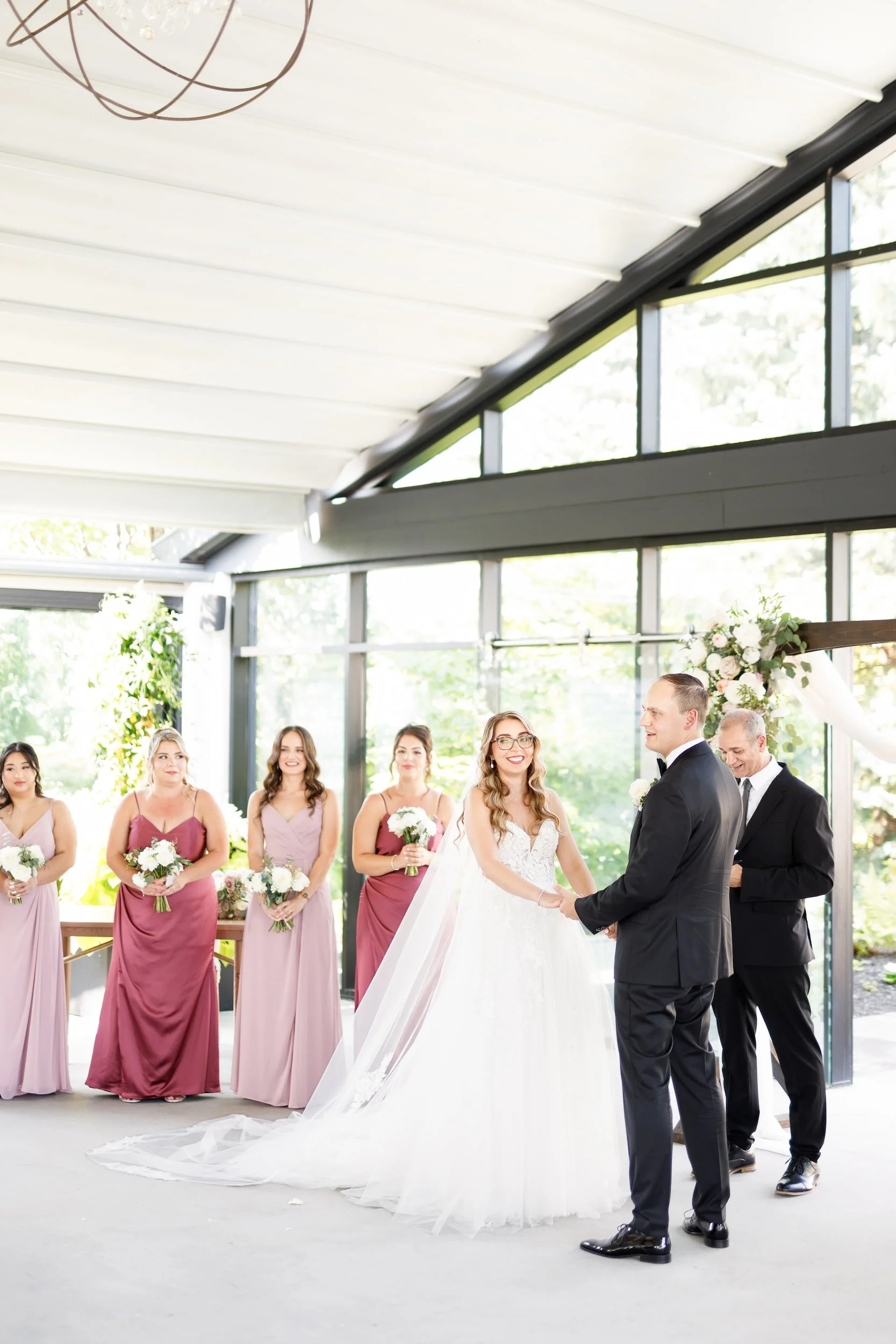 Ceremony moment beneath glass pavilion at Whistle Bear Golf Club in Cambridge, Ontario