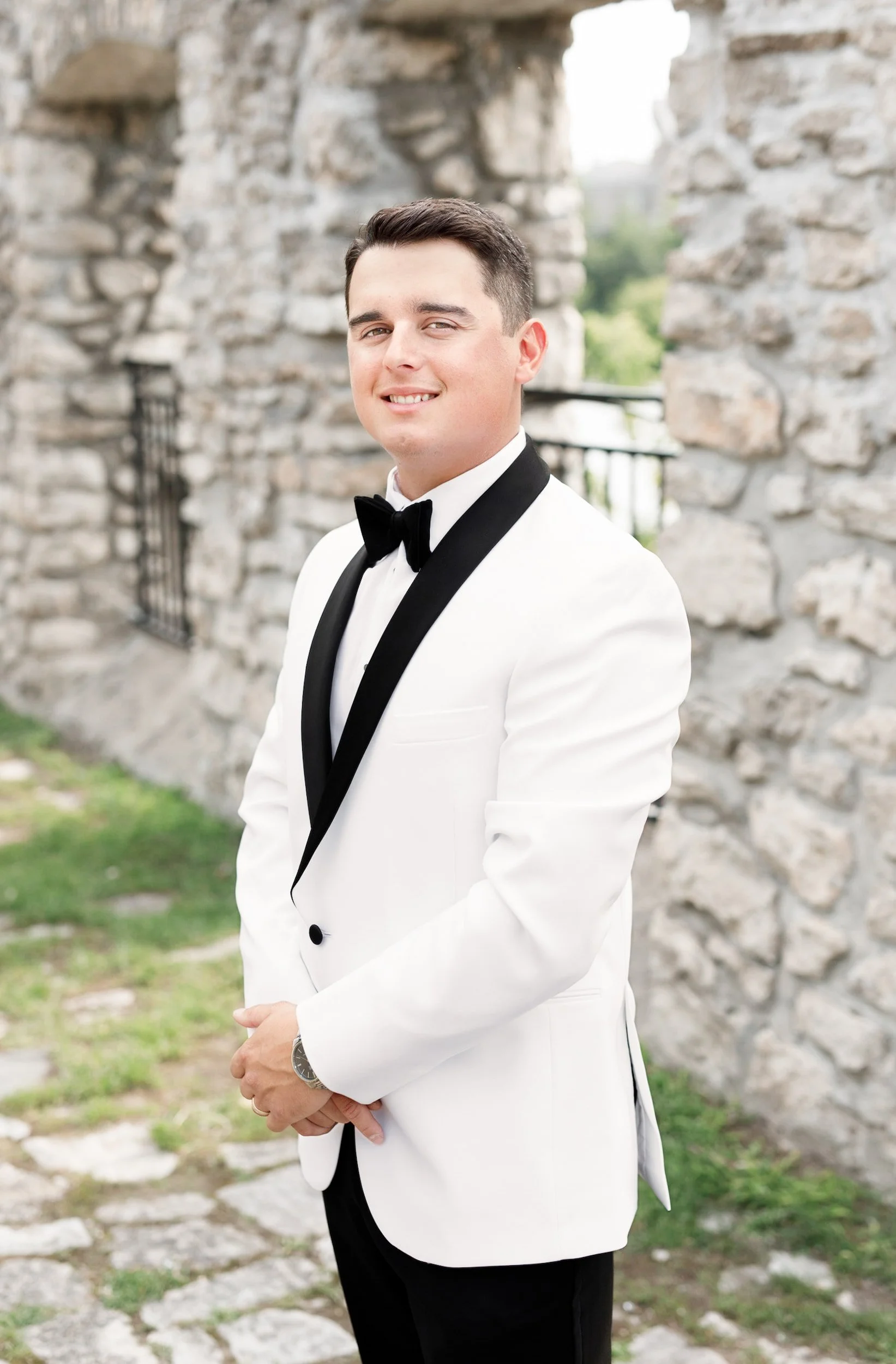 Groom portrait against historic limestone walls at Cambridge Mill in Cambridge, Ontario
