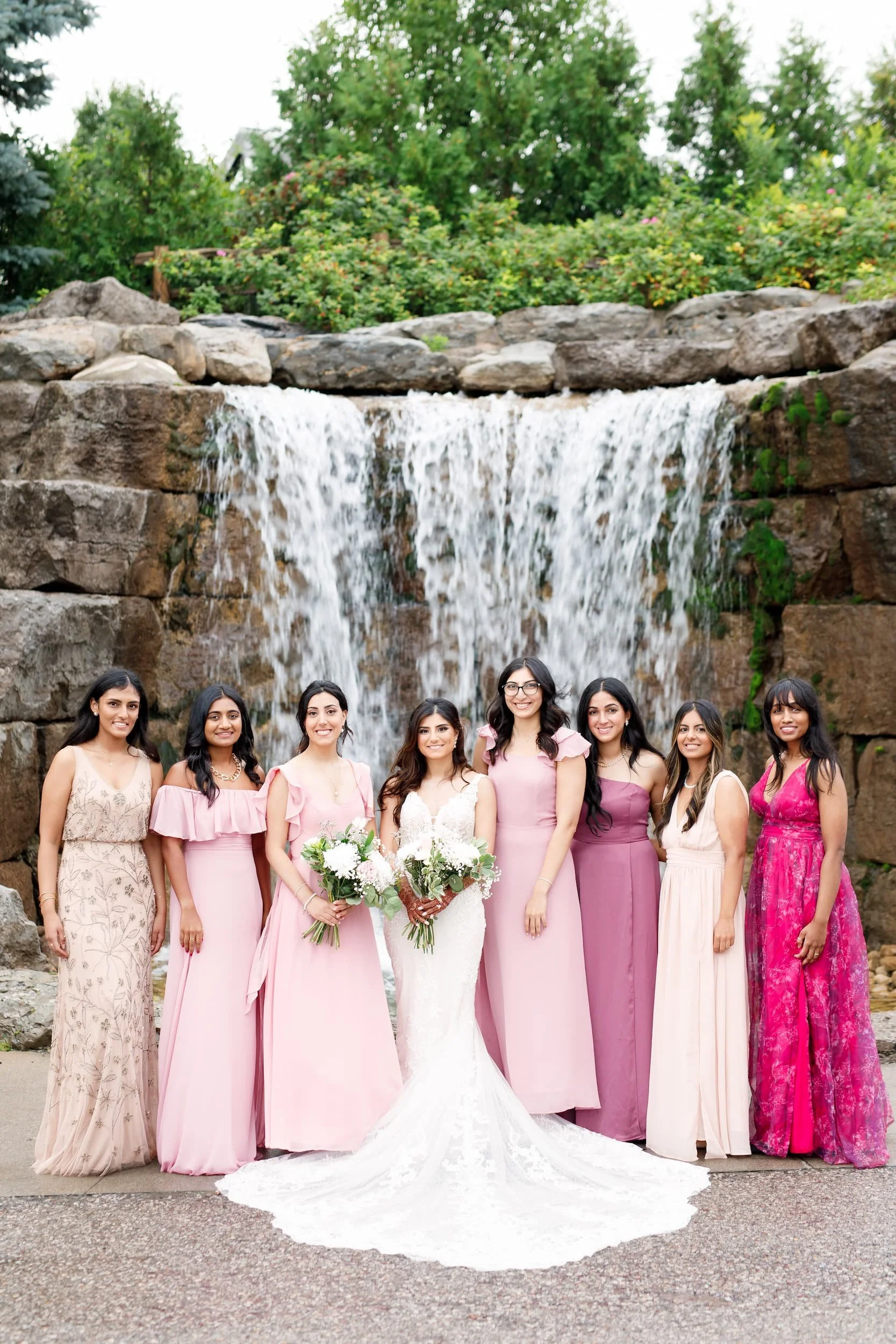 Bridal party portrait in front of waterfall feature at Whistle Bear Golf Club wedding in Cambridge, Ontario