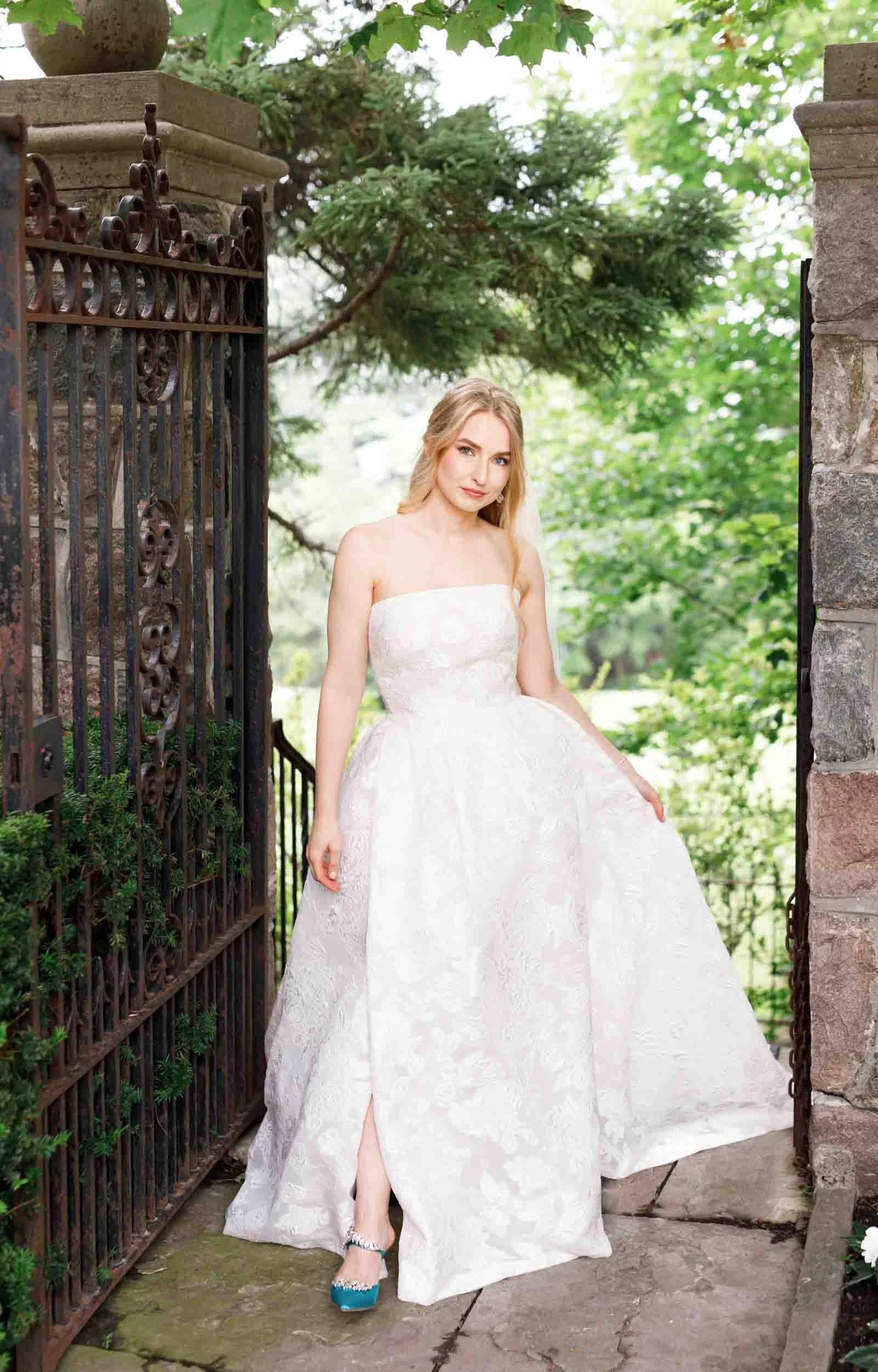 Bridal portrait framed by wrought iron gates at Graydon Hall Manor