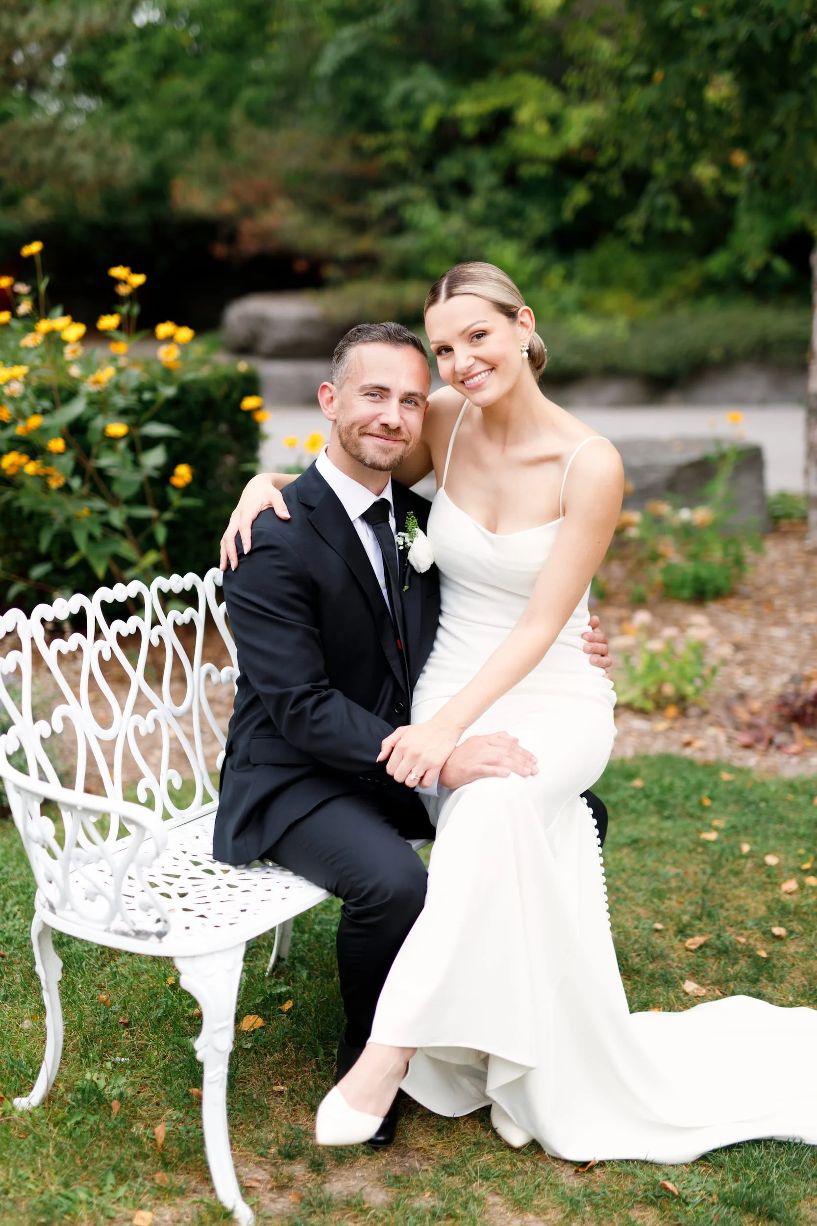 Bride and groom seated together for outdoor wedding portraits at The Manor Event Venue in King, Ontario