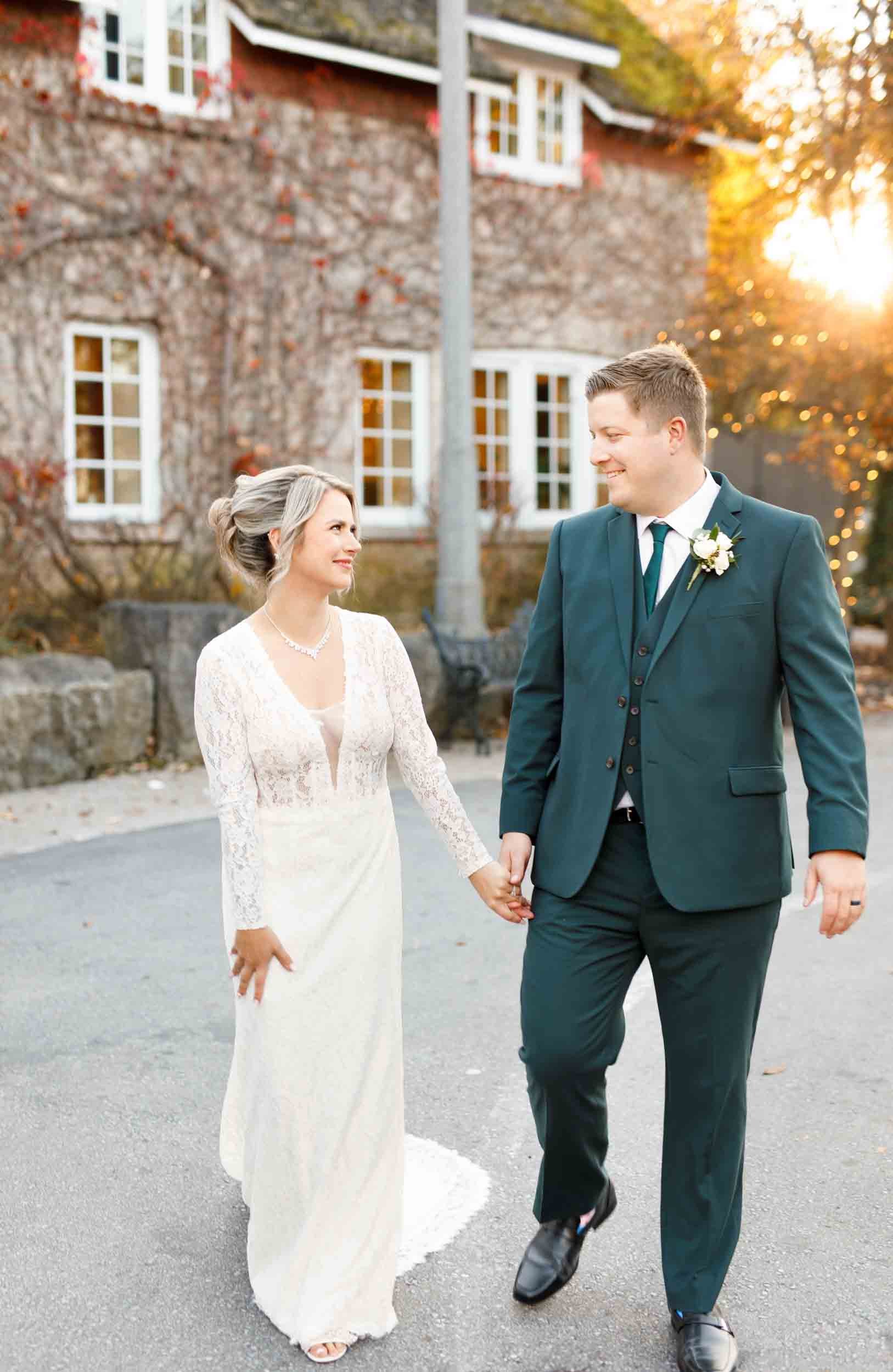 Bride and groom walking outside the Ancaster Mill in Ancaster, Ontario