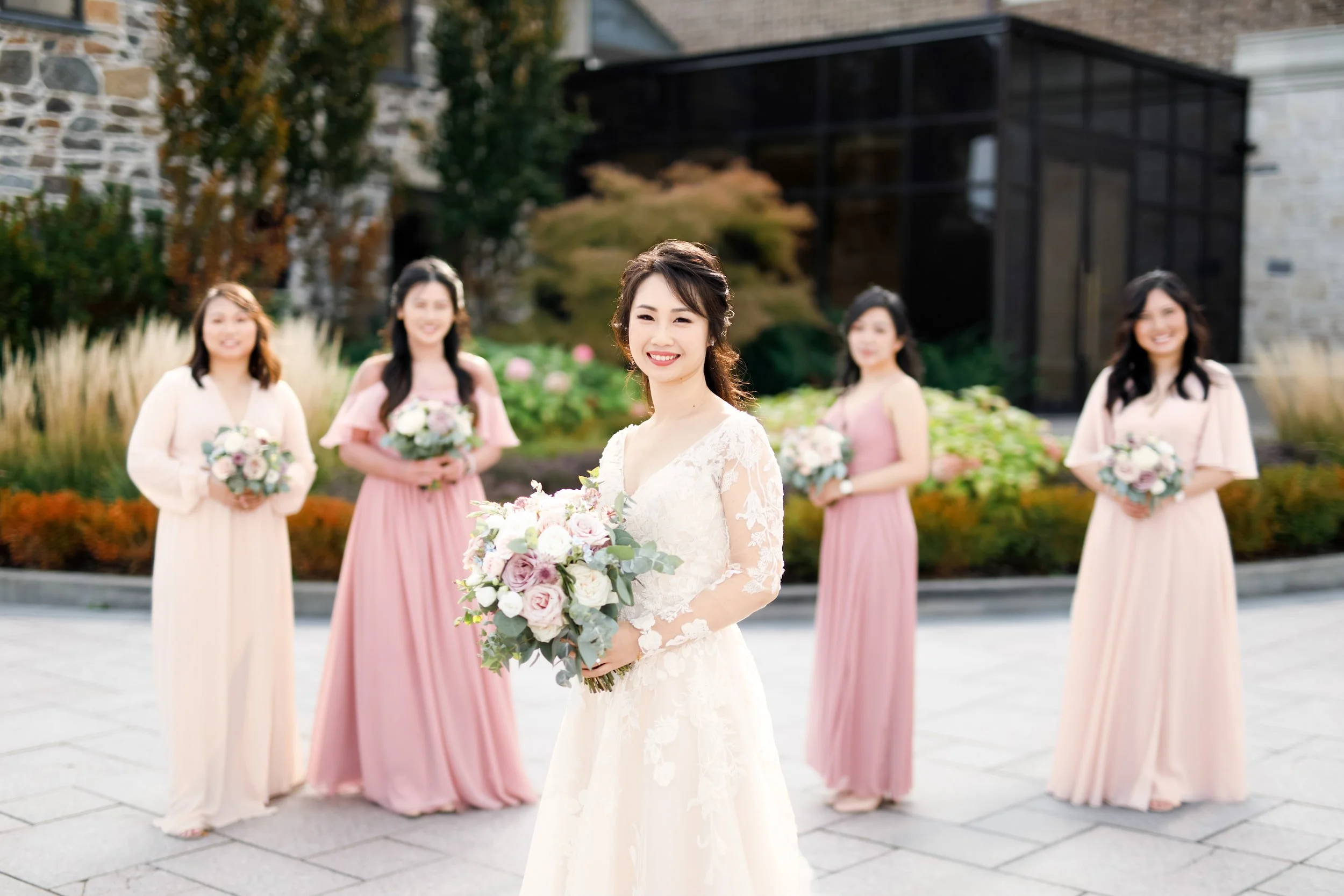 Bride with bridesmaids in the Arlington Estate courtyard in Vaughan