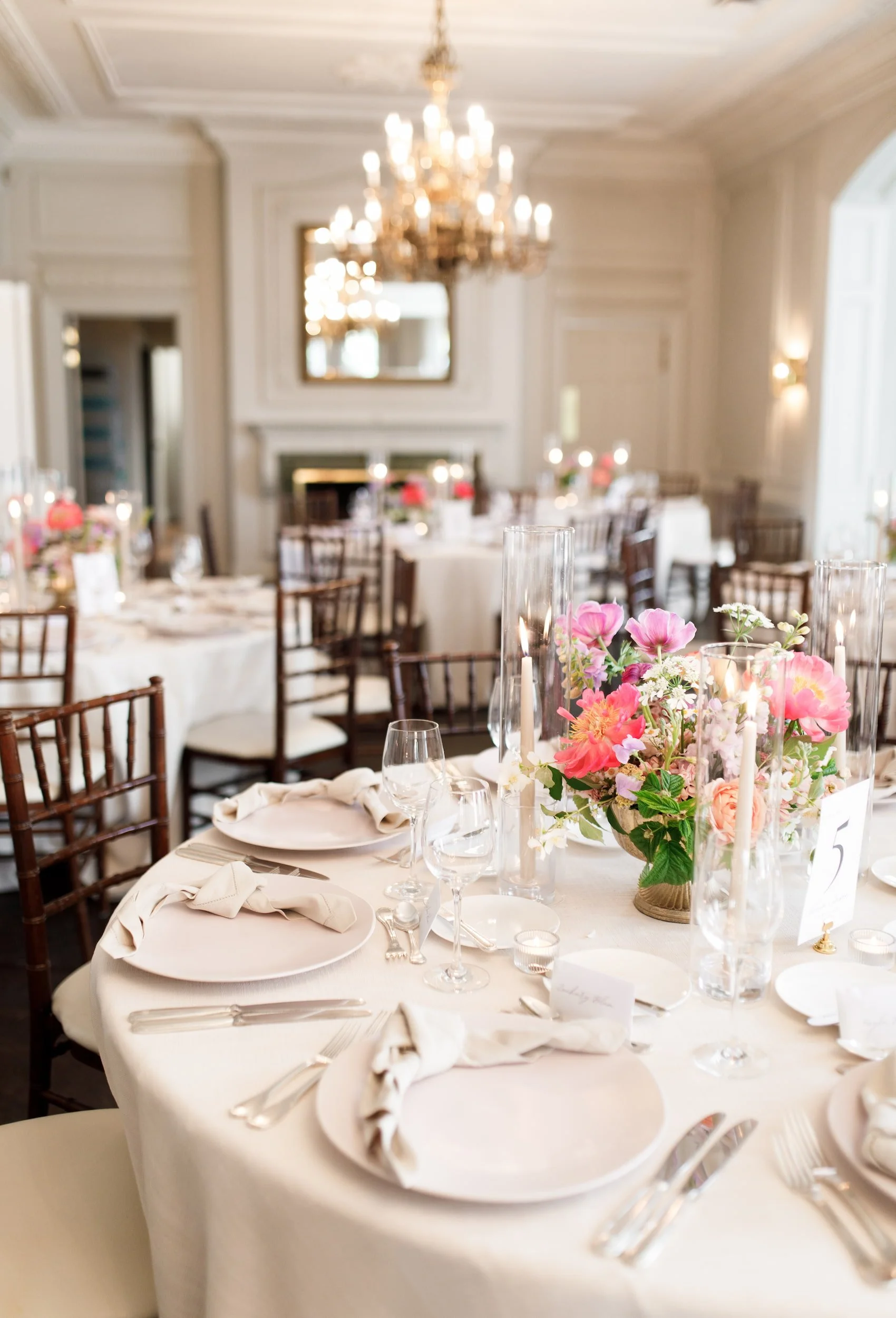 Reception table setting with floral centrepieces at Graydon Hall Manor