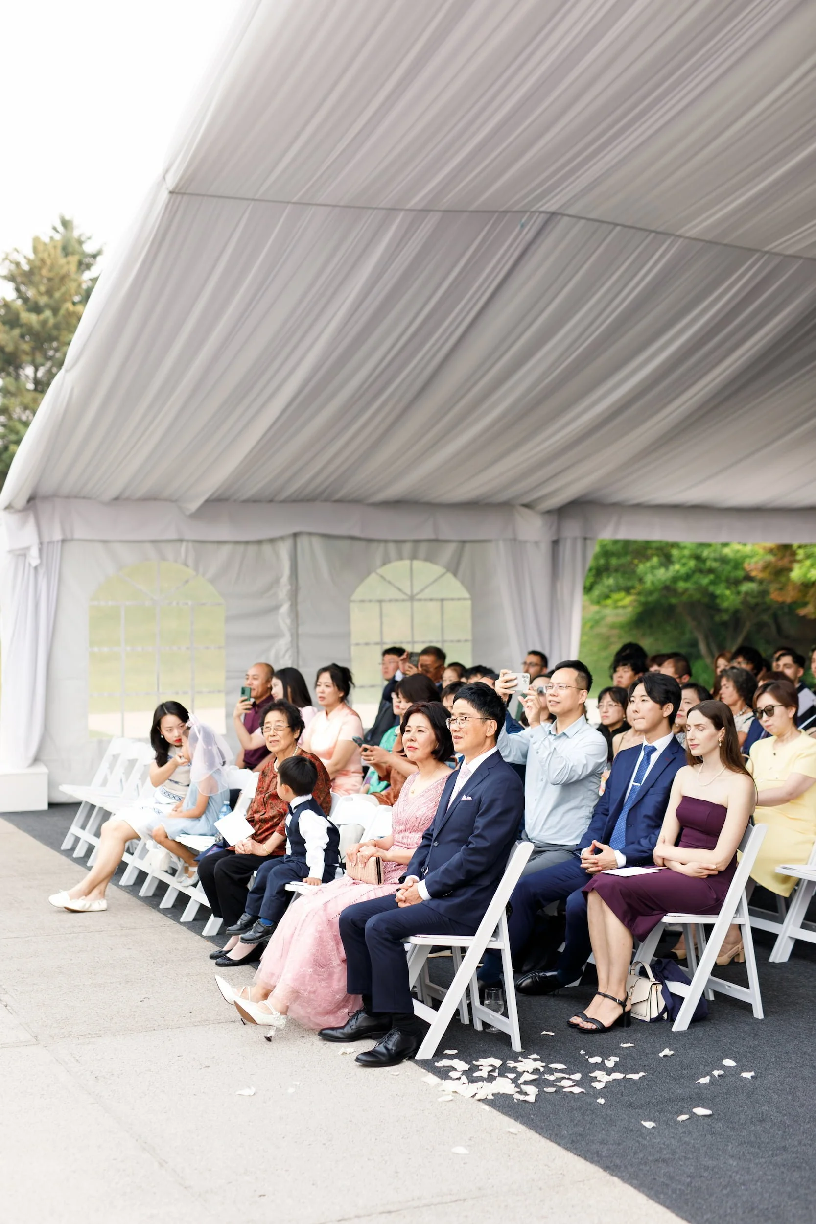 Guests seated inside tented ceremony space at The Manor Event Venue in King, Ontario